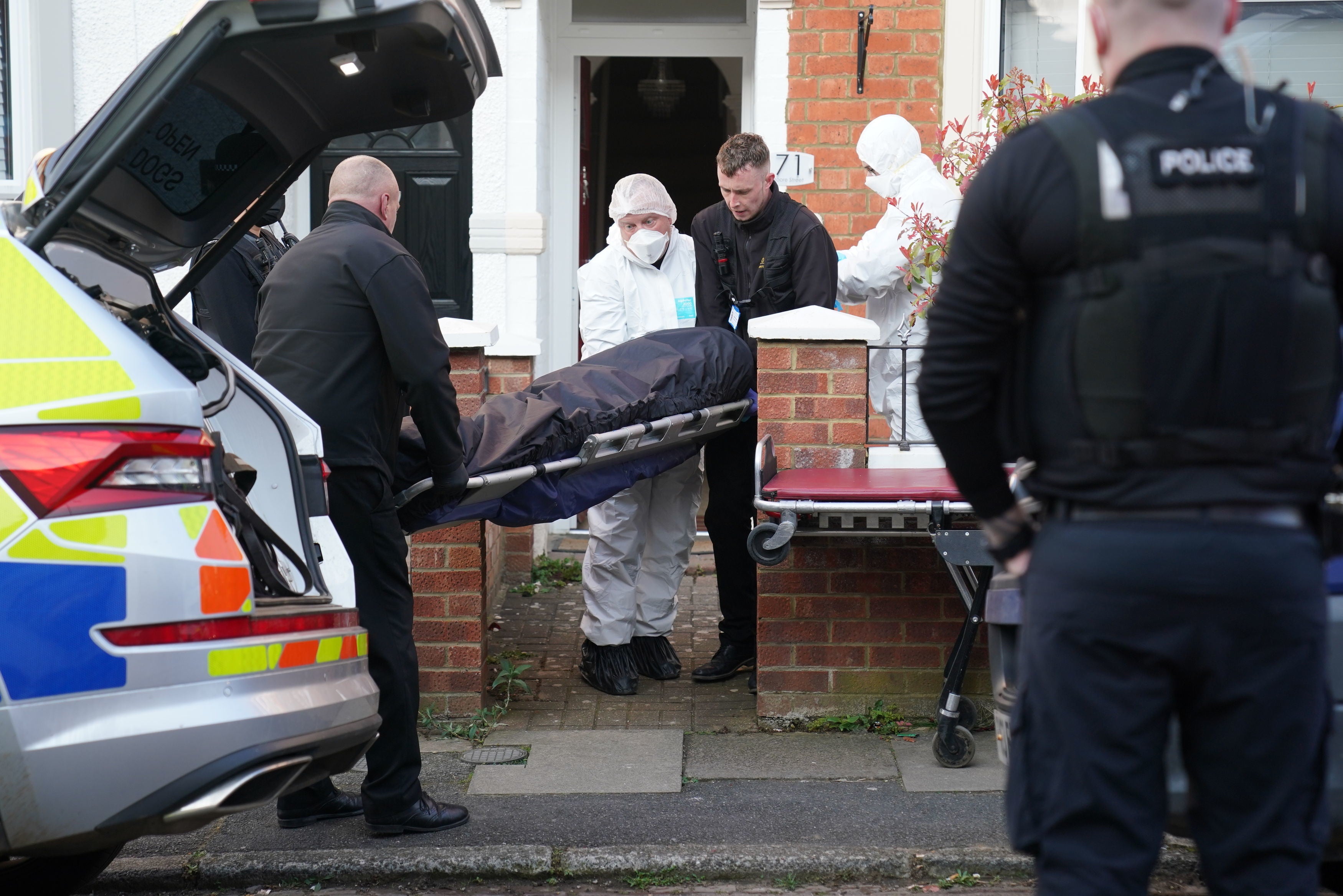 The body is removed from the house in Moore Street, Kingsley, Northampton on Sunday