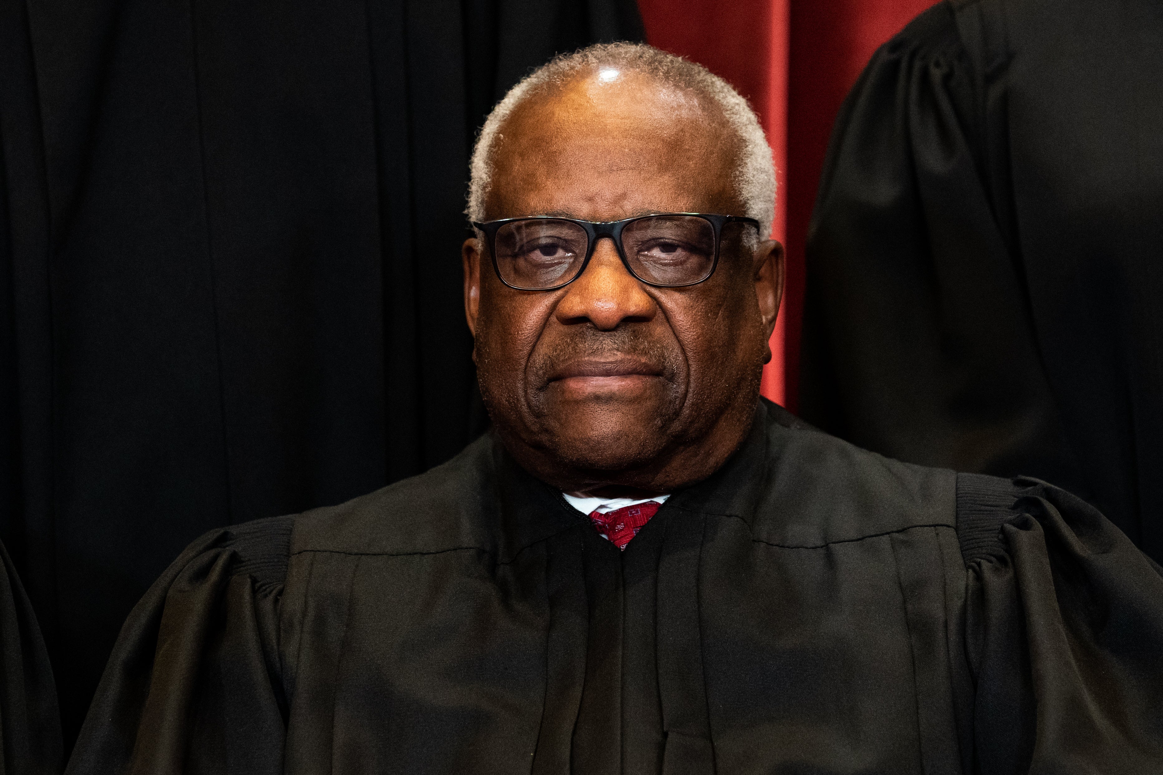 Associate Justice Clarence Thomas sits during a group photo of the Justices at the Supreme Court in Washington, DC on April 23, 2021.