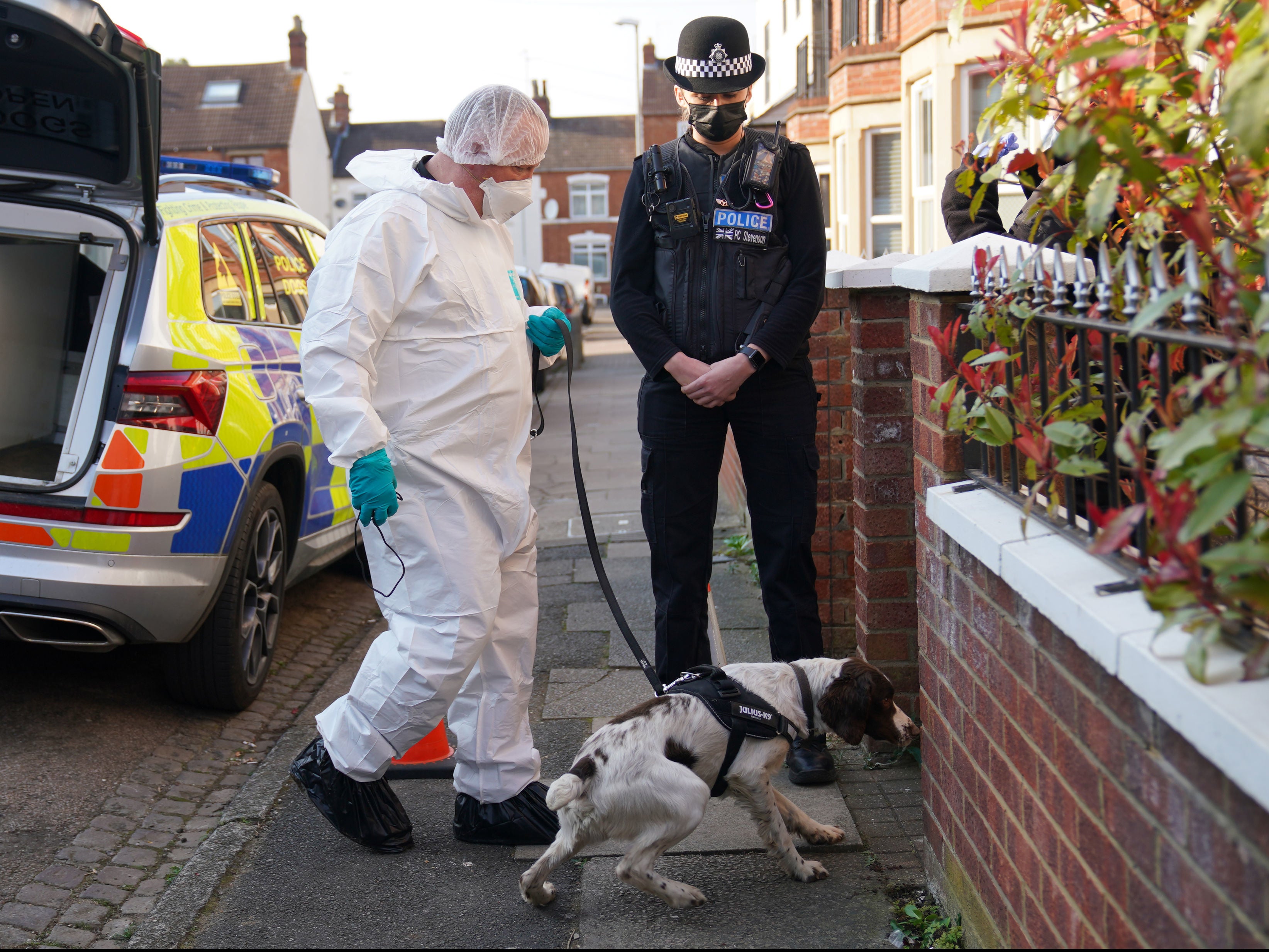 Specialist search teams, including a cadaver dog, carry out a search of a house in Moore Street, Kingsley, Northampton, following the discovery of a man’s body in the rear garden