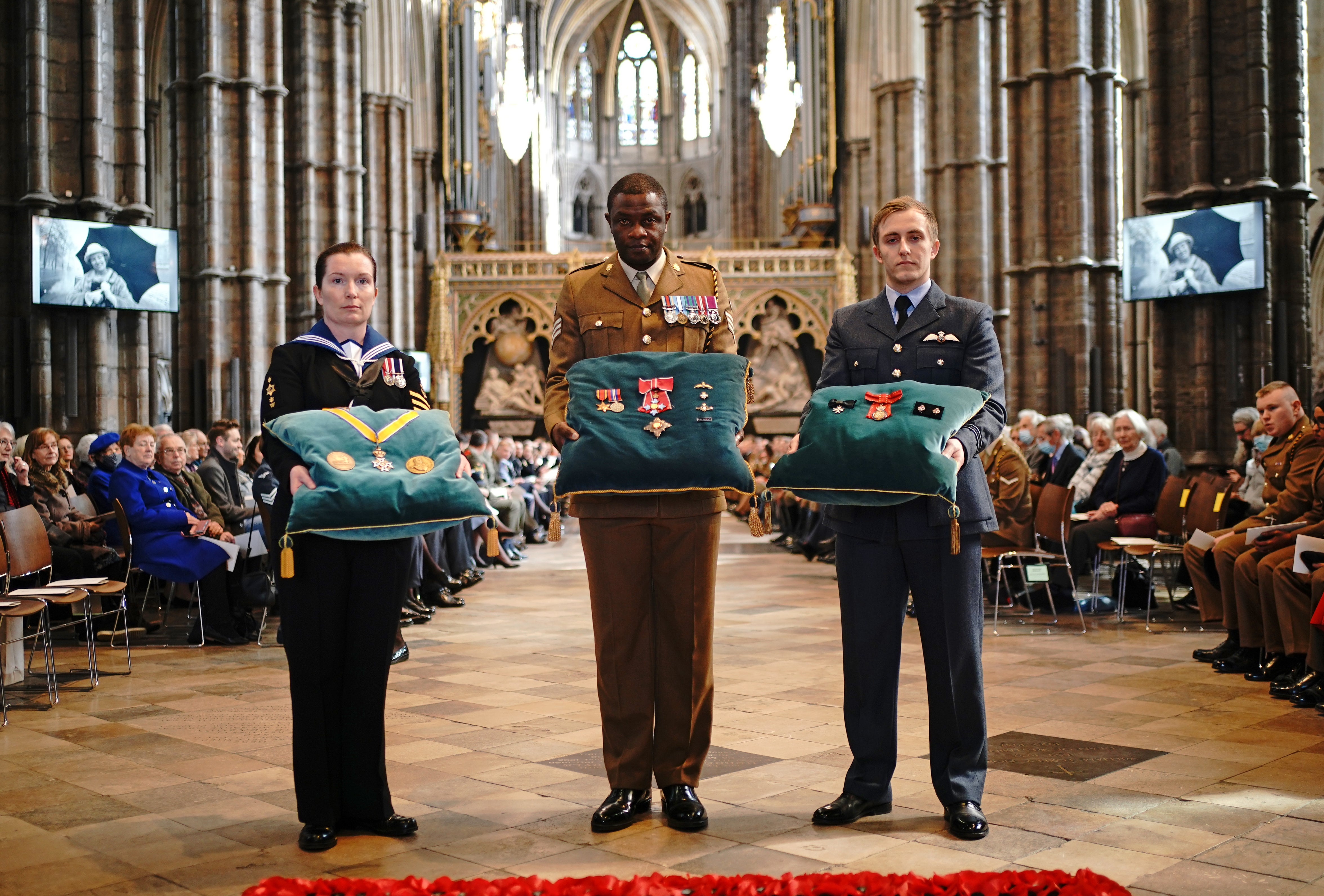 Members of the Armed Forces hold medals belonging to Dame Vera Lynn ahead of the Service of Thanksgiving for the Forces’ sweetheart at Westminster Abbey, London. The singer and entertainer lifted people’s spirits during the Second World War with songs including We’ll Meet Again and The White Cliffs Of Dover. She died in June 2020, aged 103 (Yui Mok/PA)