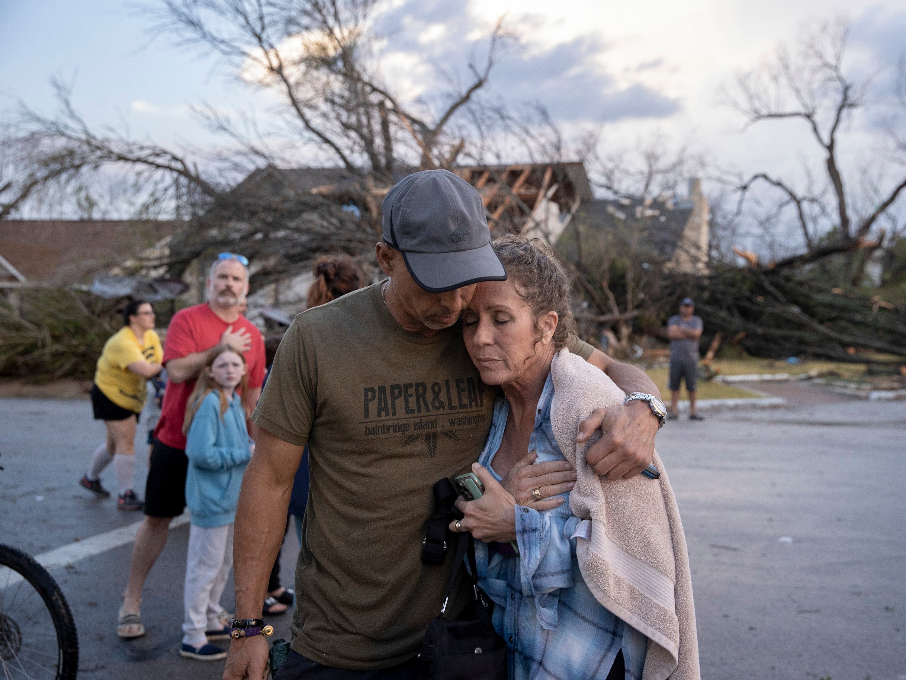 Michael Talamantez comforts his girlfriend Derry Schroer after Talamantez' house on Stratford Drive in Round Rock