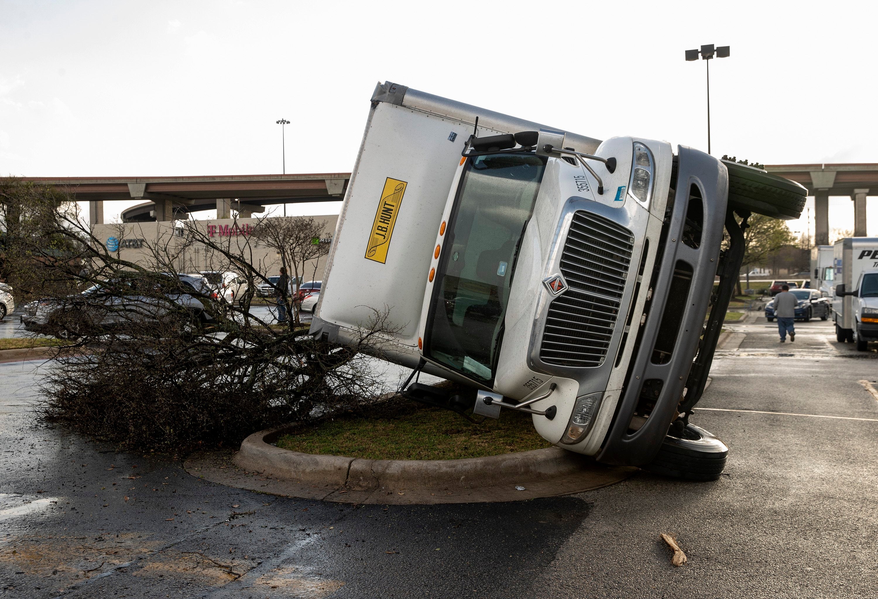 A truck is knocked on its side after a tornado hit a shopping center near I-35 and SH 45 in Round Rock, Texas