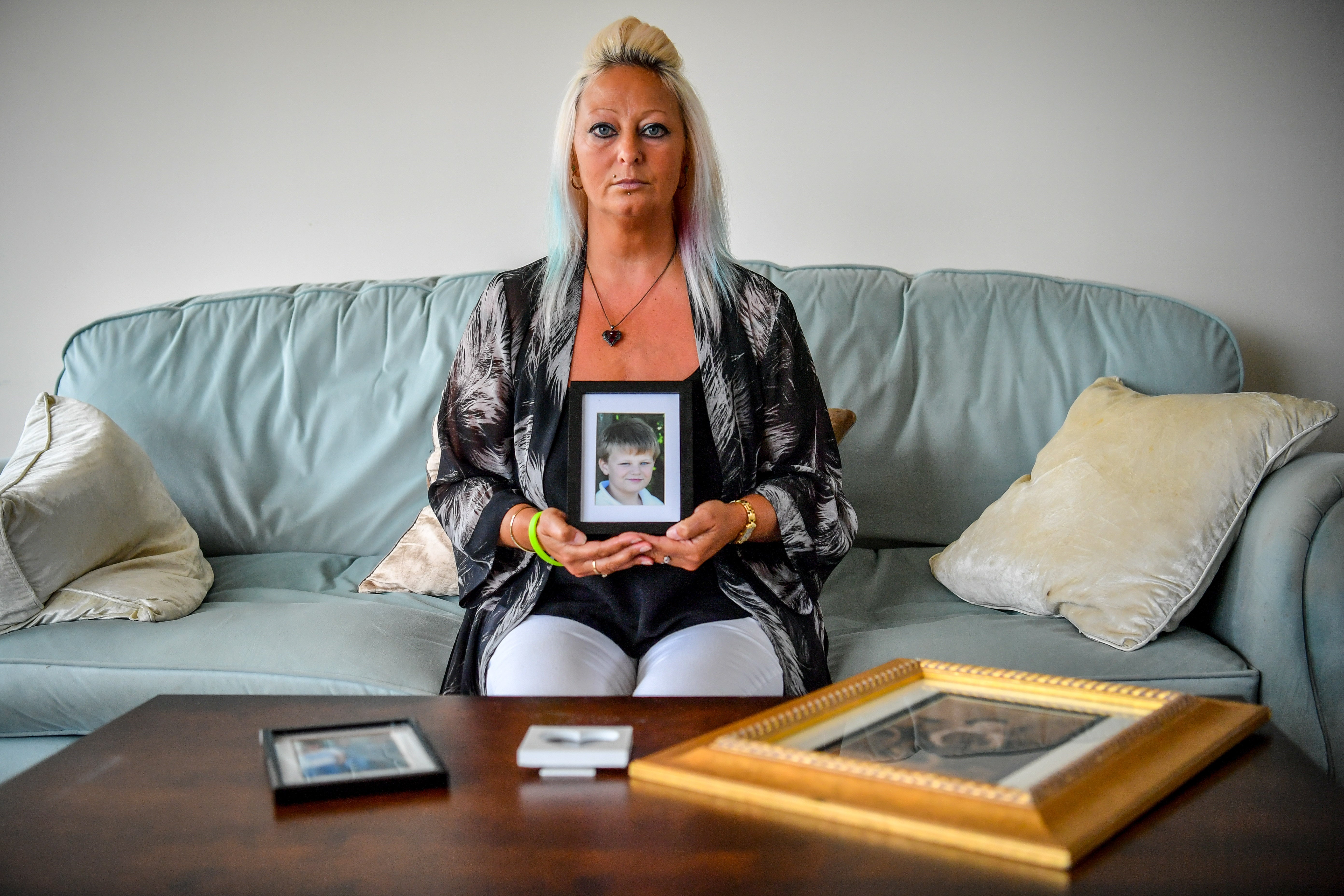 Charlotte Charles, mother of Harry Dunn, holding a photograph of him aged 14