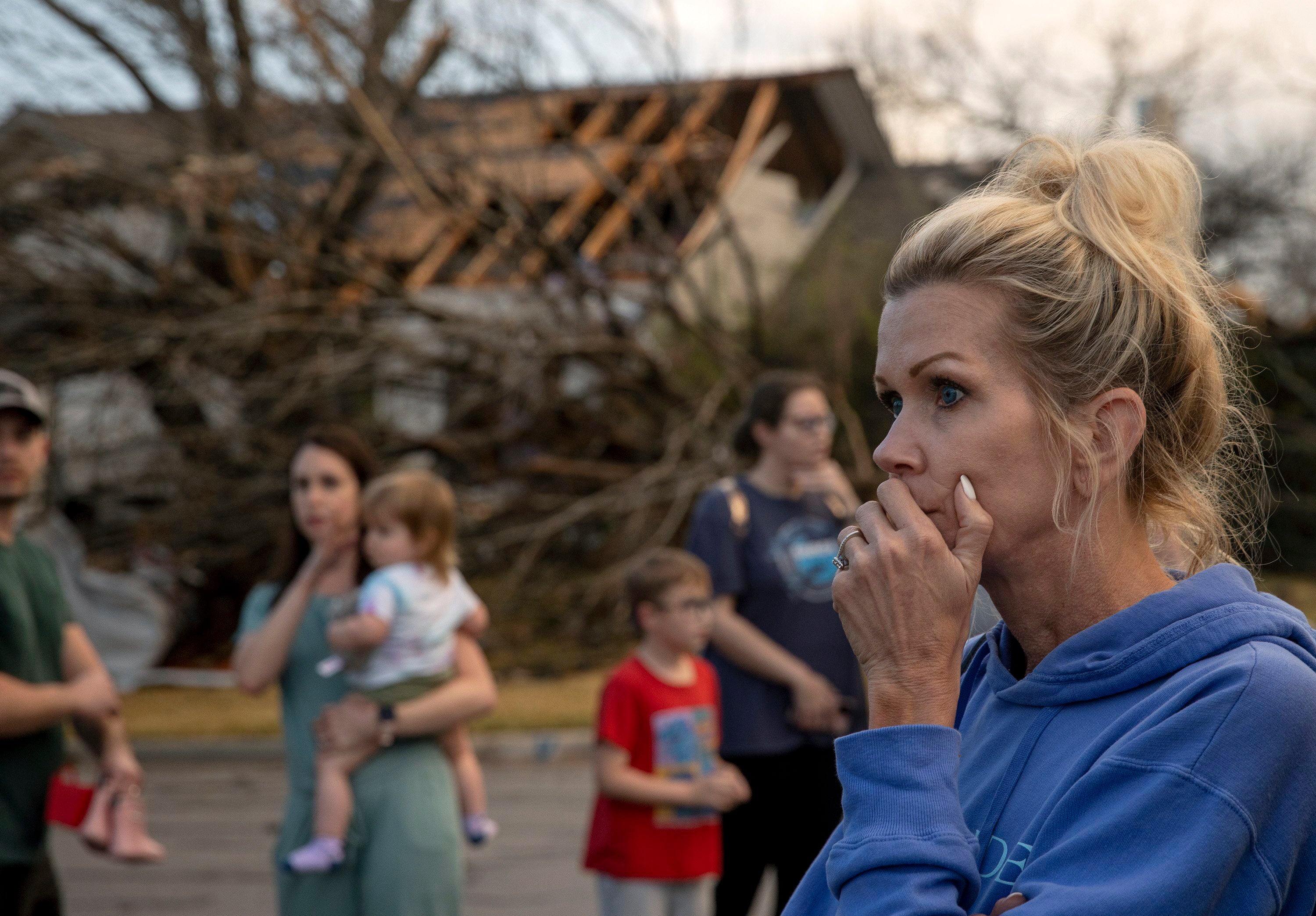 Kristie Wofford looks at the damage after a tornado heavily damaged several homes on Oxford Drive in Round Rock, Texas, on Monday