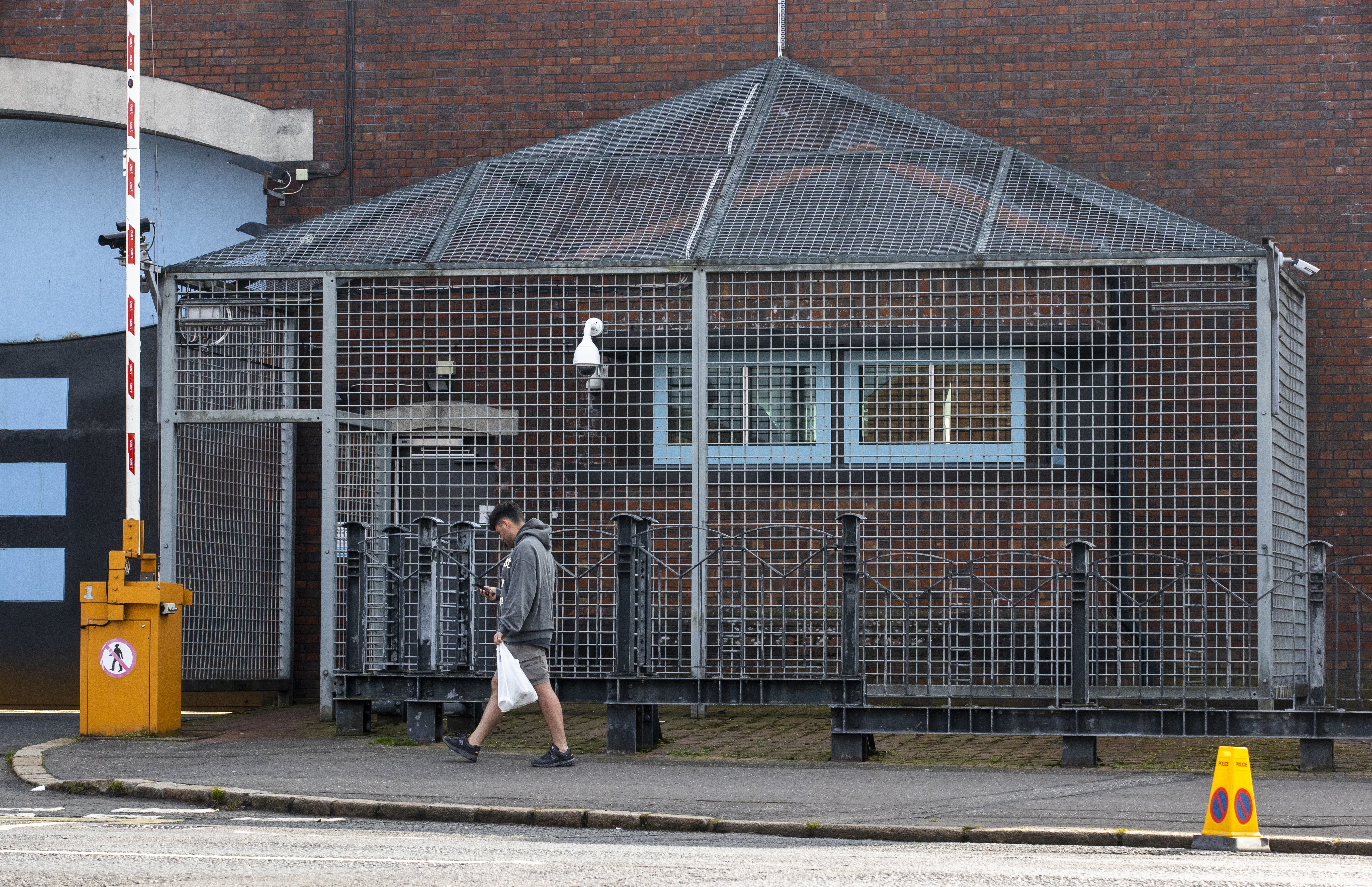 A man walks past Lisburn Road Police Station in south Belfast, as the terrorism threat level in Northern Ireland has been lowered from severe to substantial for the first time in 12 years, Secretary of State Brandon Lewis announced (Liam McBurney/PA)