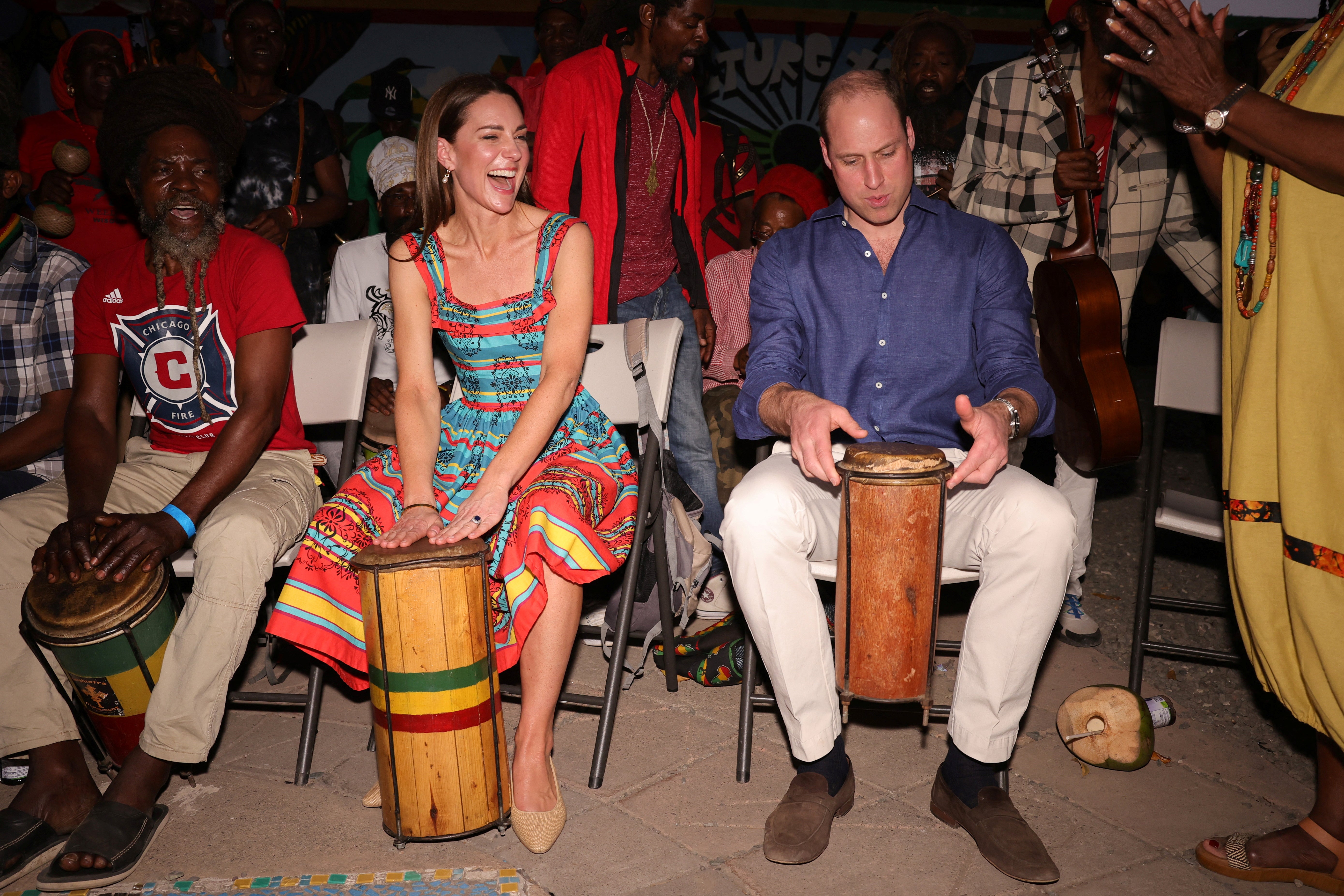 Prince William, Duke of Cambridge and Catherine, Duchess of Cambridge play music during a visit to Trench Town Culture Yard Museum where Bob Marley used to live