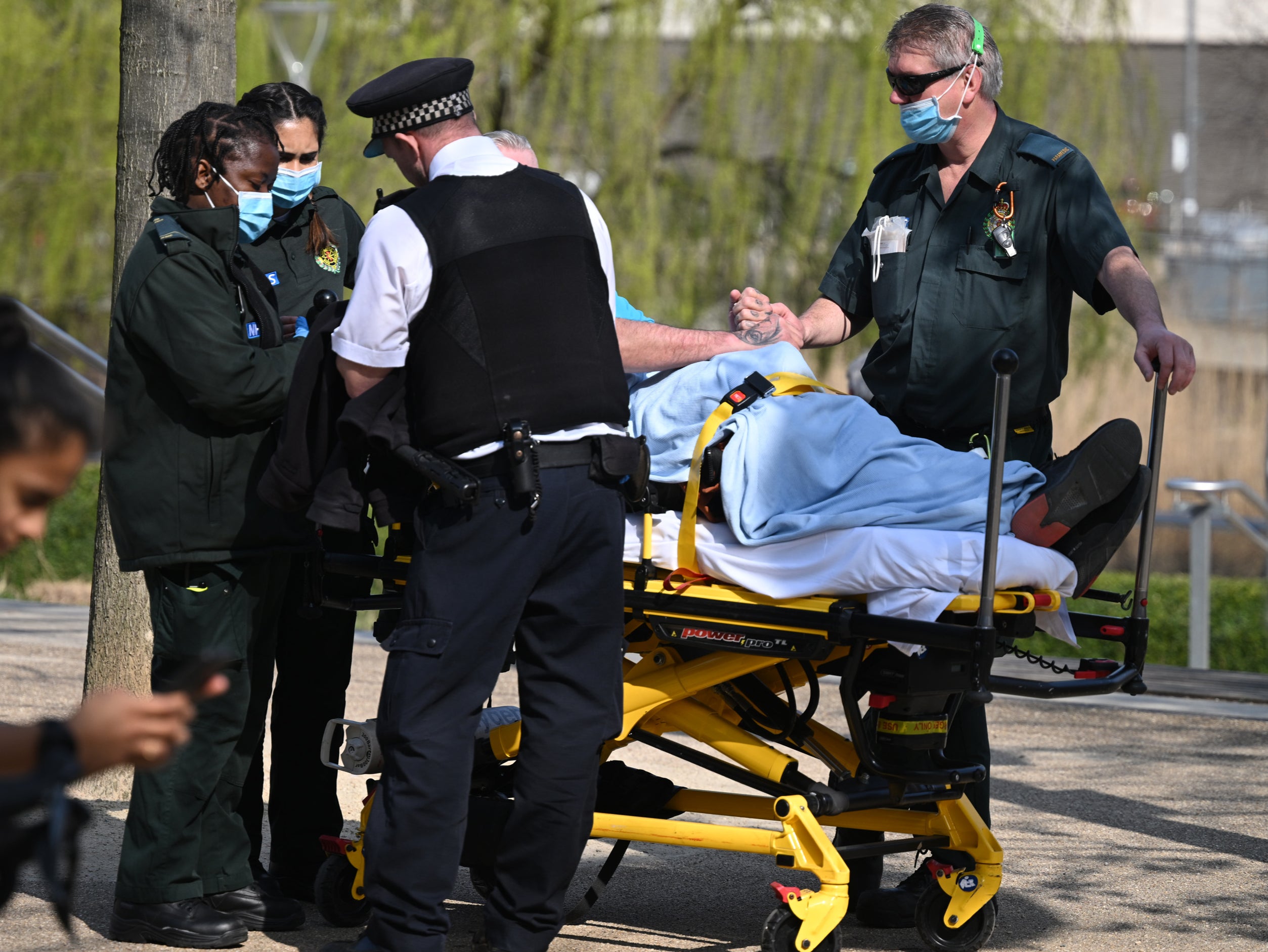 A casualty is treated by paramedics after emergency services evacuated the pool