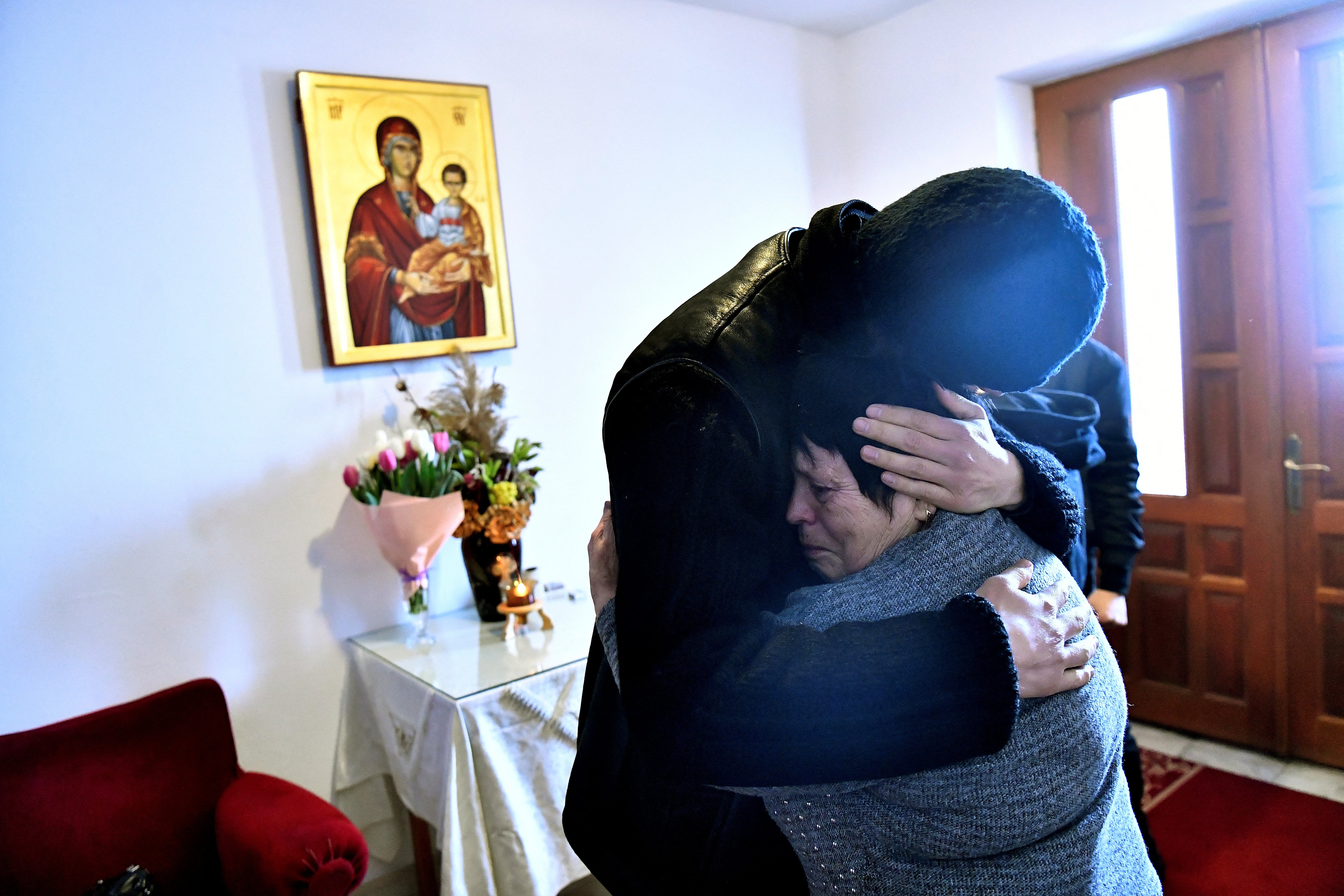 Father Gherasim Soca comforts Svetlana as she cries