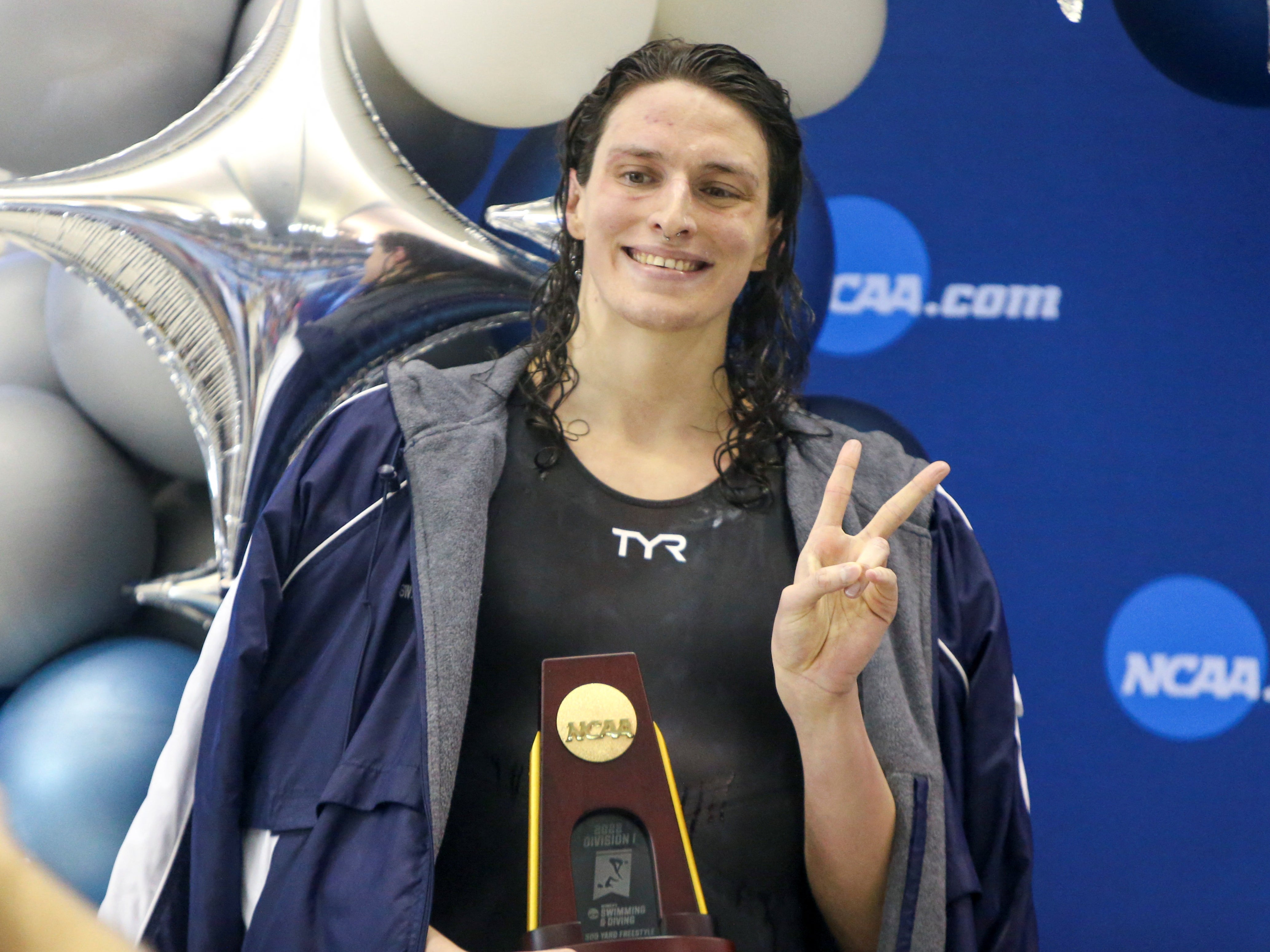 Lia Thomas holds her trophy after winning the 500 yard freestyle at the NCAA women’s swimming championship on 17 March 2022