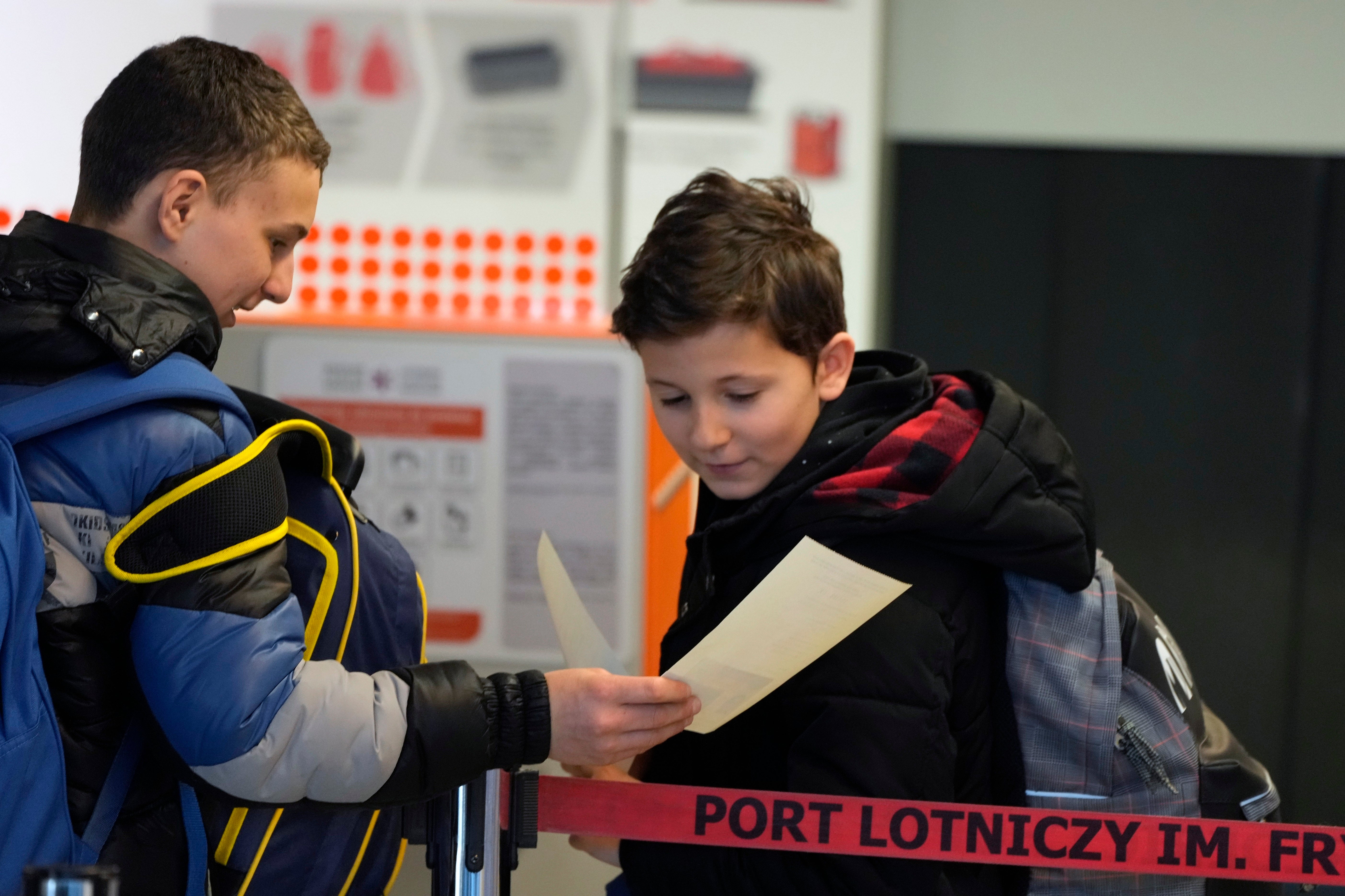 Ukrainian children wait for a flight to the United Kingdom at Chopin airport, in Warsaw