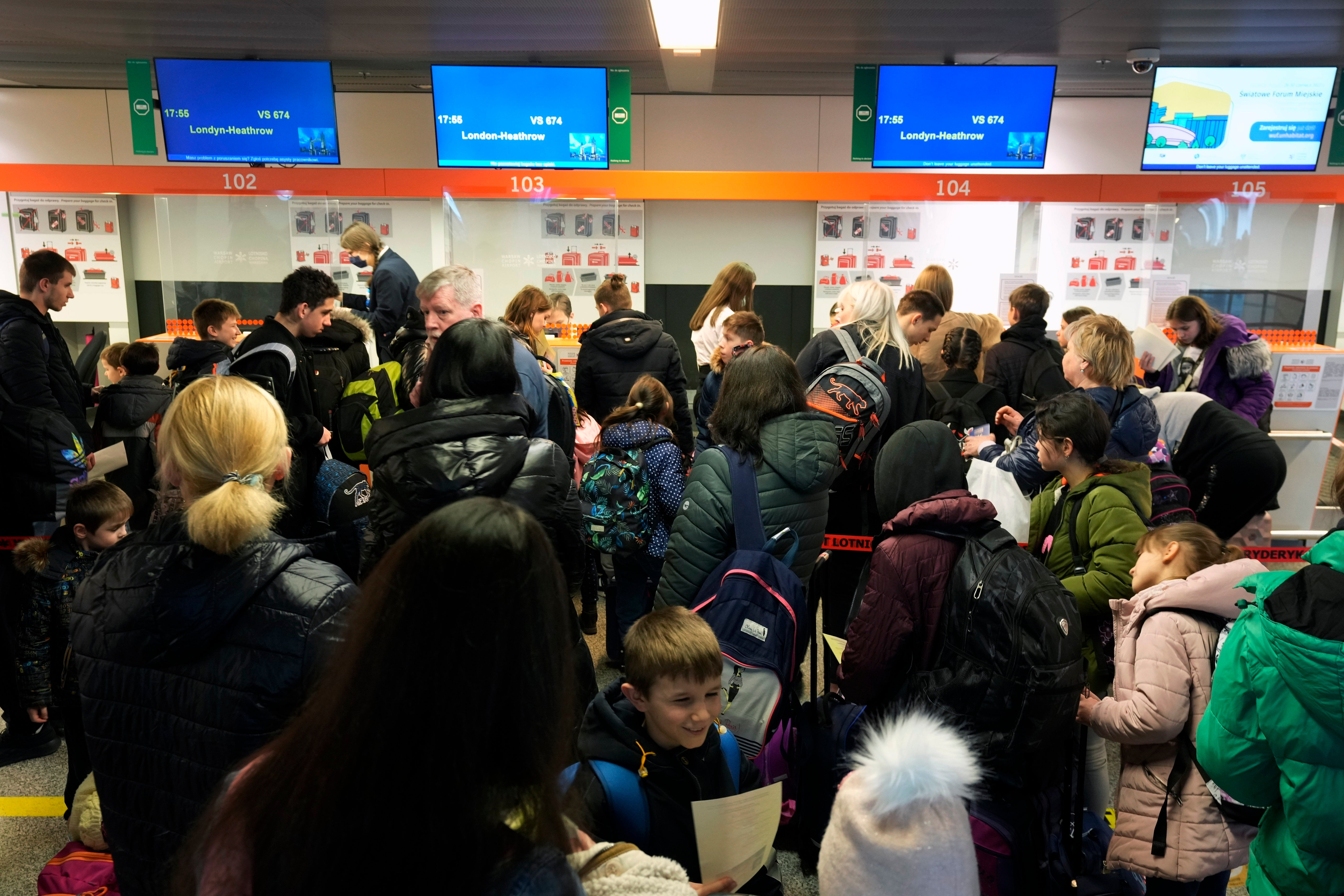 The orphans wait for a flight to the United Kingdom at Chopin airport, in Warsaw, Poland