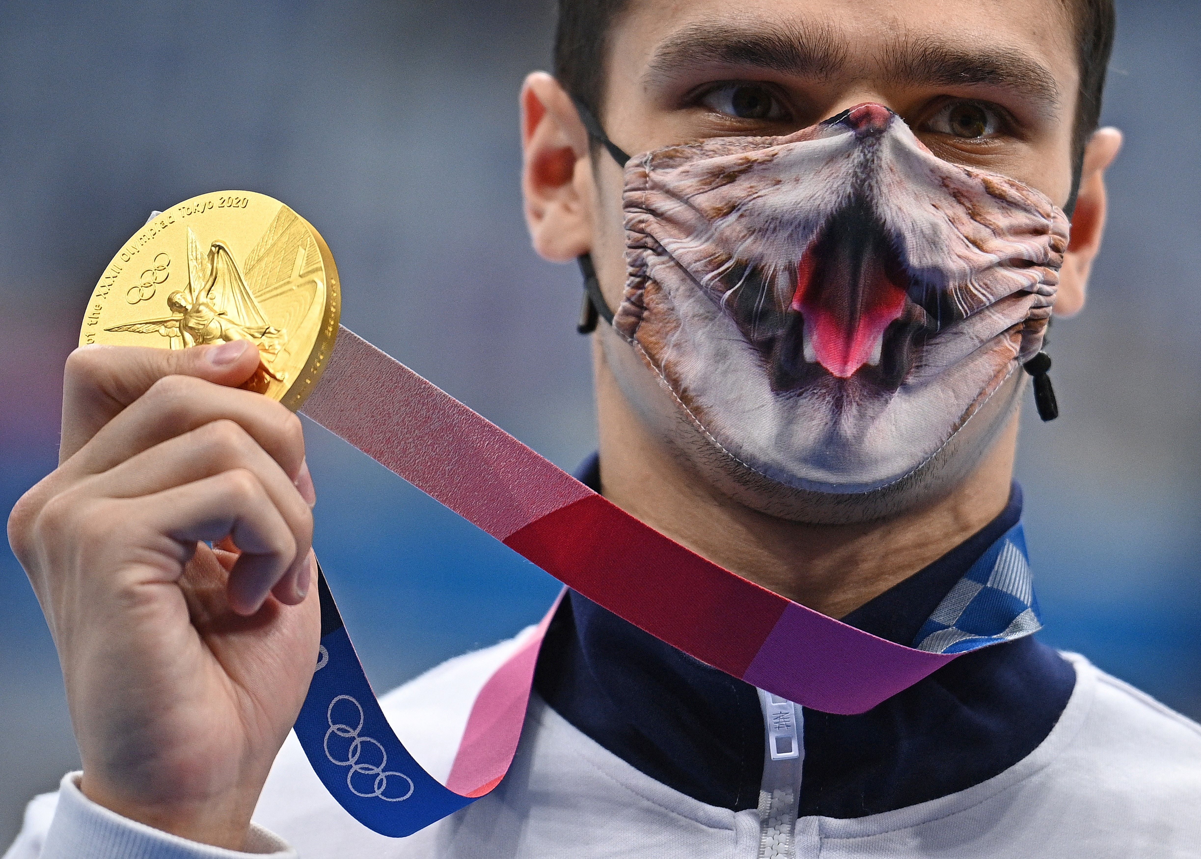 Evgeny Rylov poses with his Olympic 200m backstroke gold medal in Tokyo