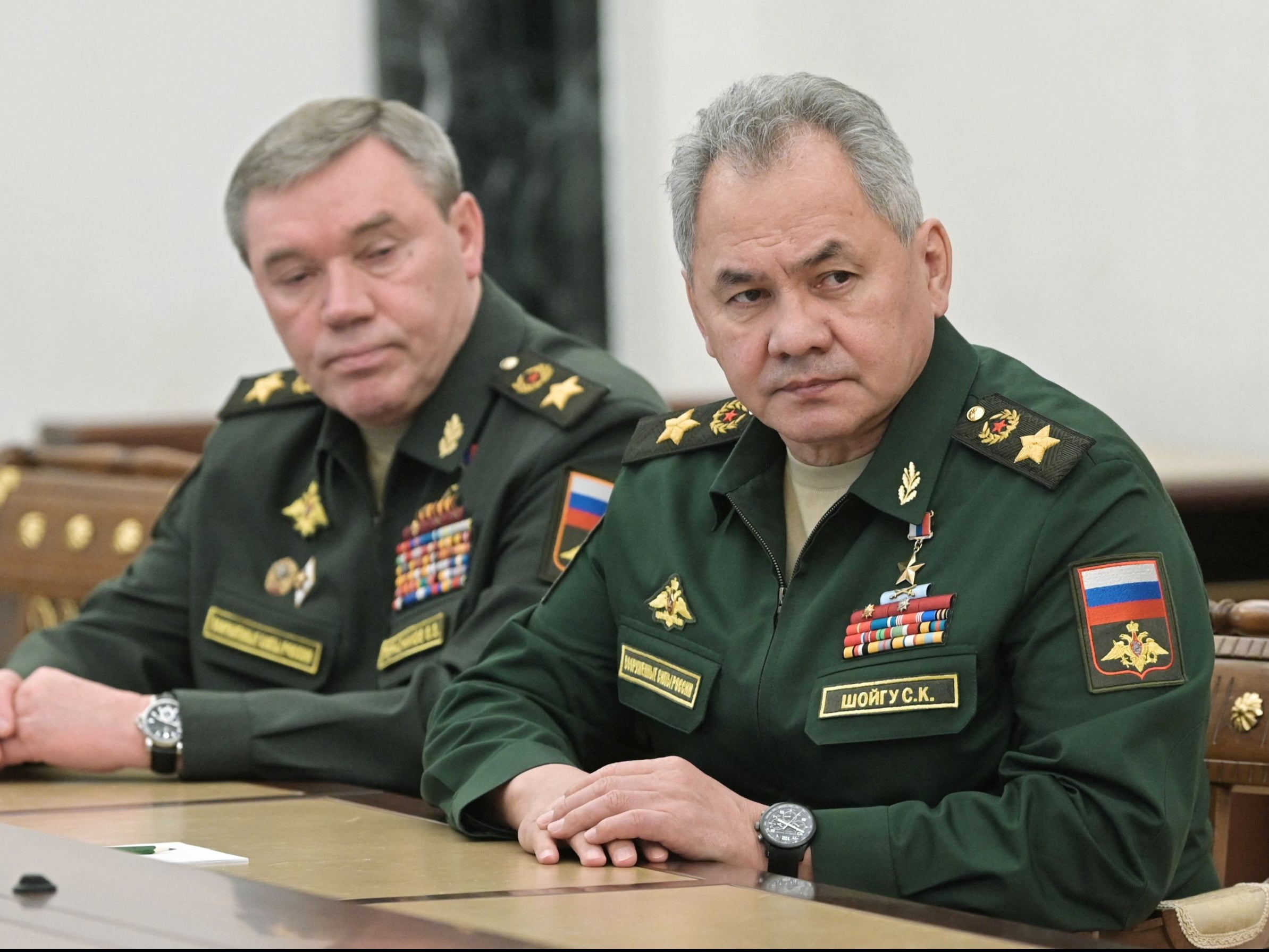 Russian Defence Minister Sergei Shoigu (R) and chief of the general staff Valery Gerasimov attend a meeting with Russian President in Moscow on 27 February