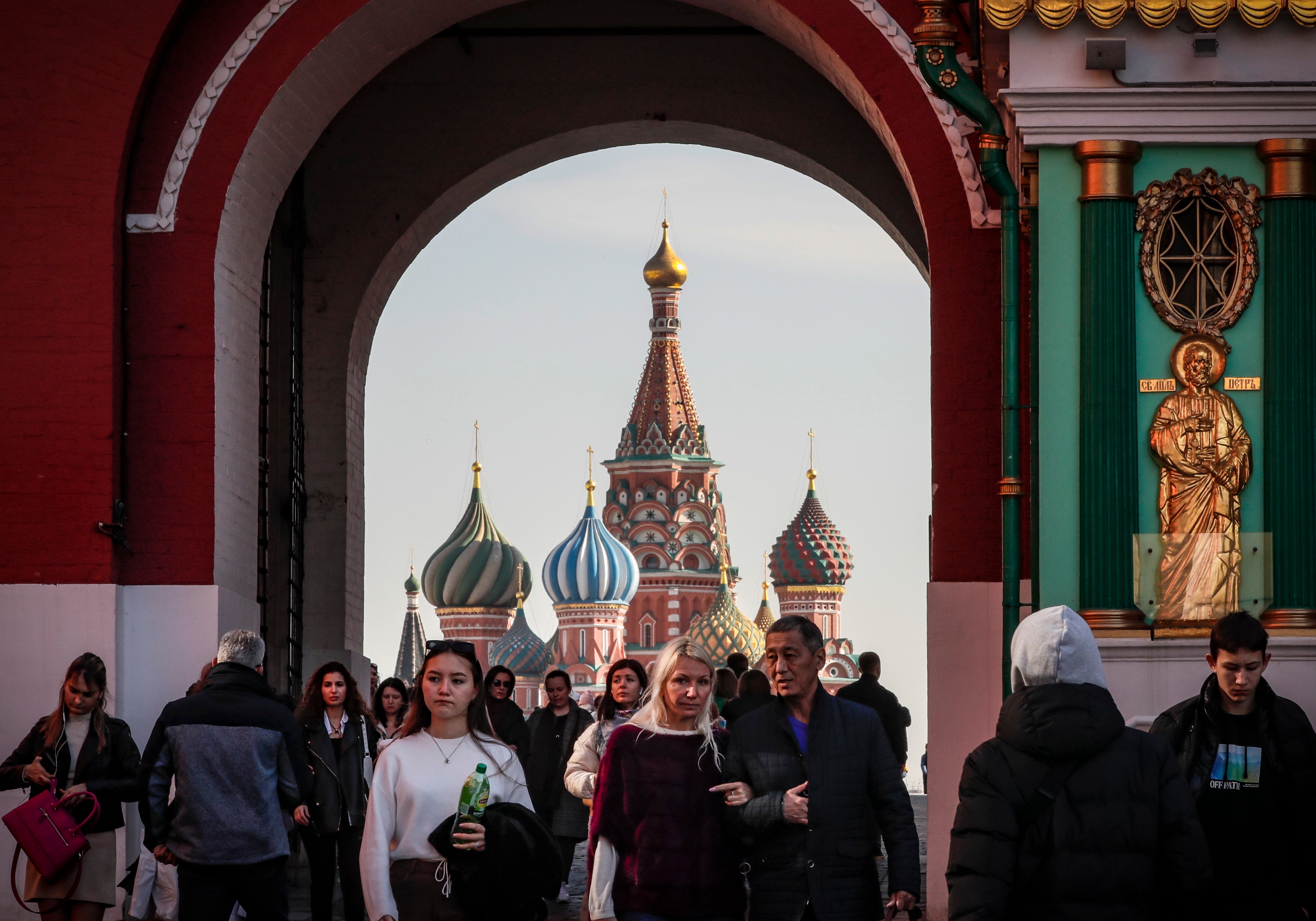 Russian people walk on Red Square in front of St. Basil’s Cathedral, Moscow