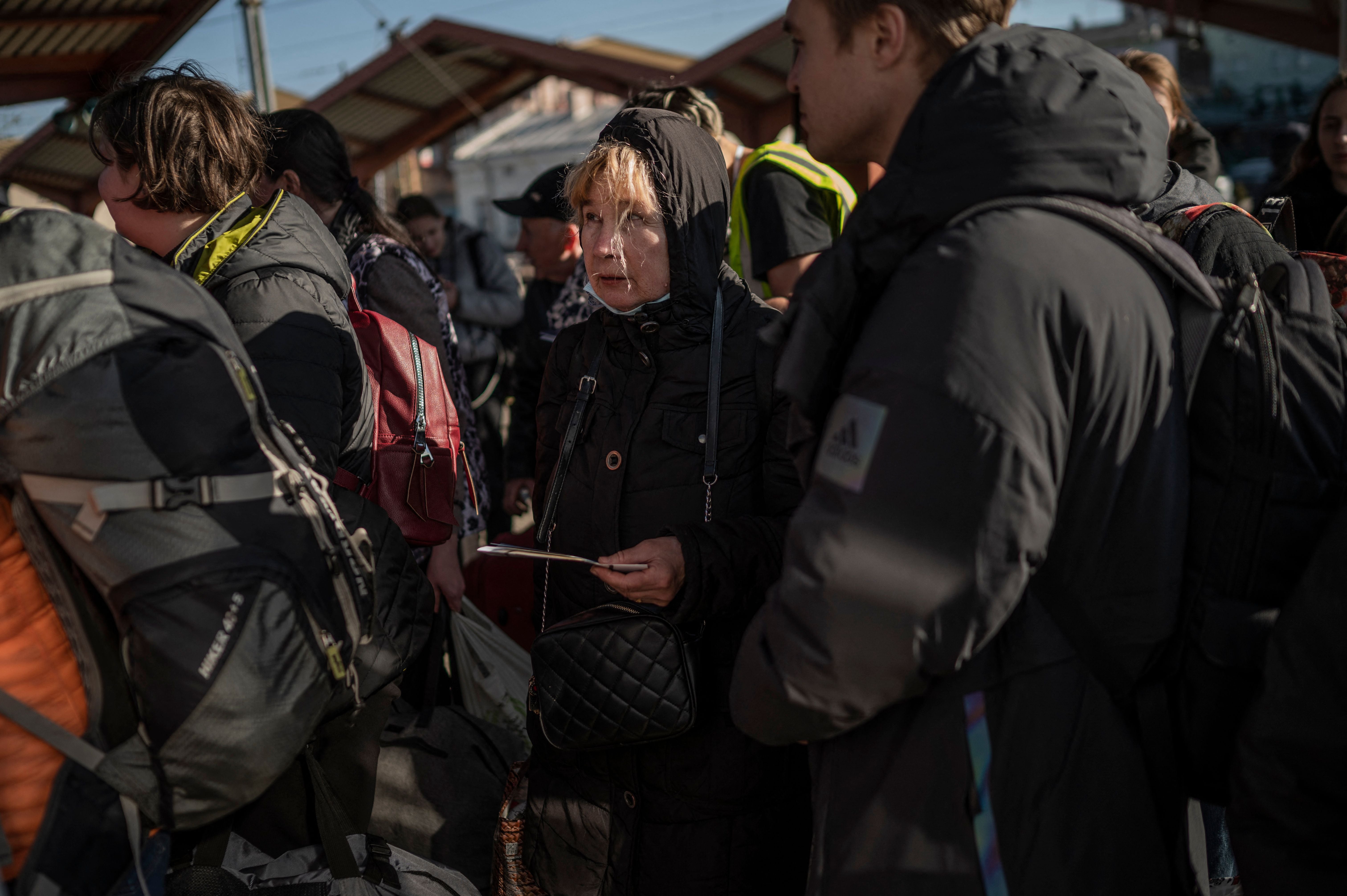 Ukrainian refugees wait to board a train en route to Warsaw at the station in Przemysl