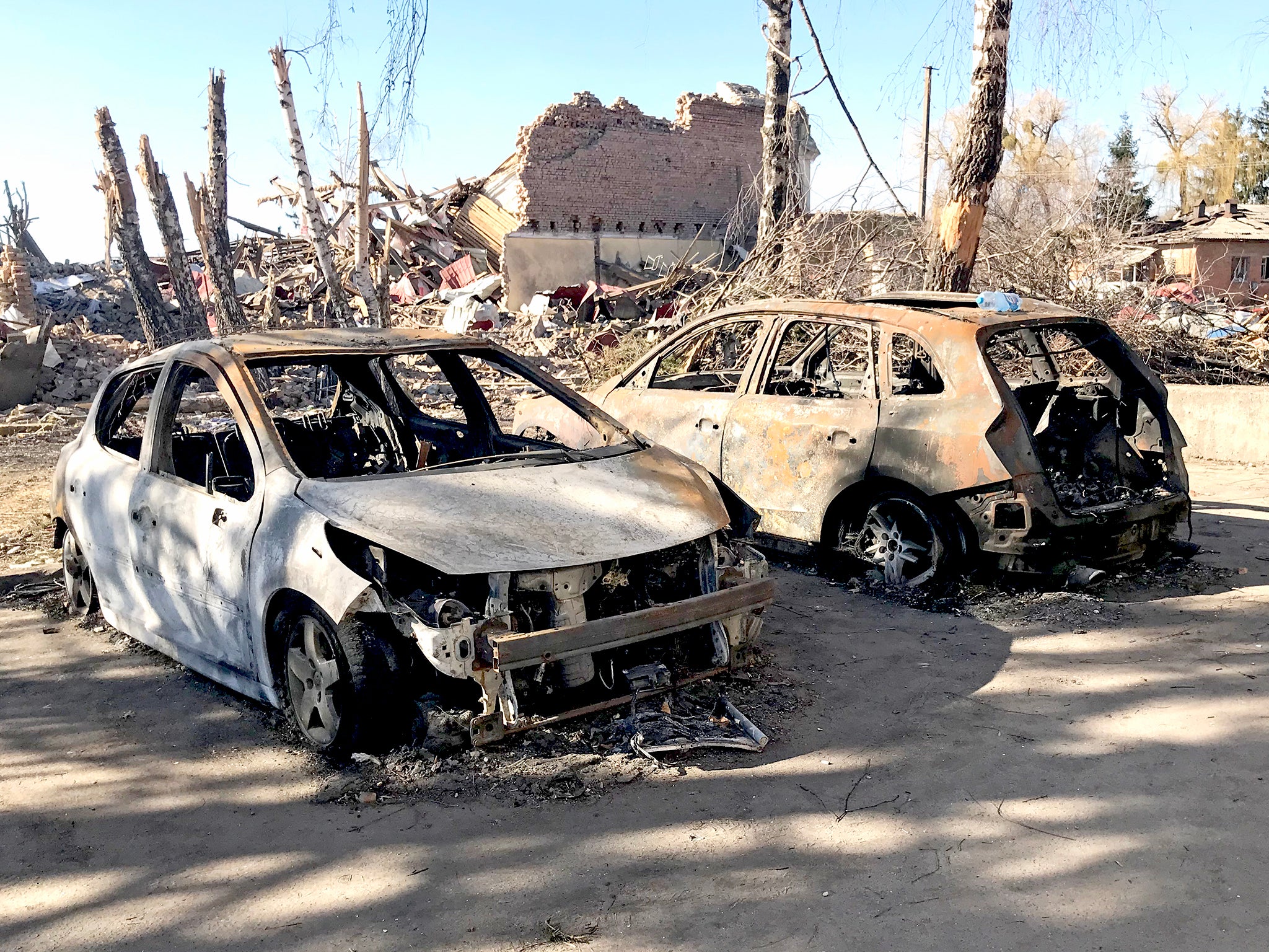 The charred remains of two cars line the streets of Makariv