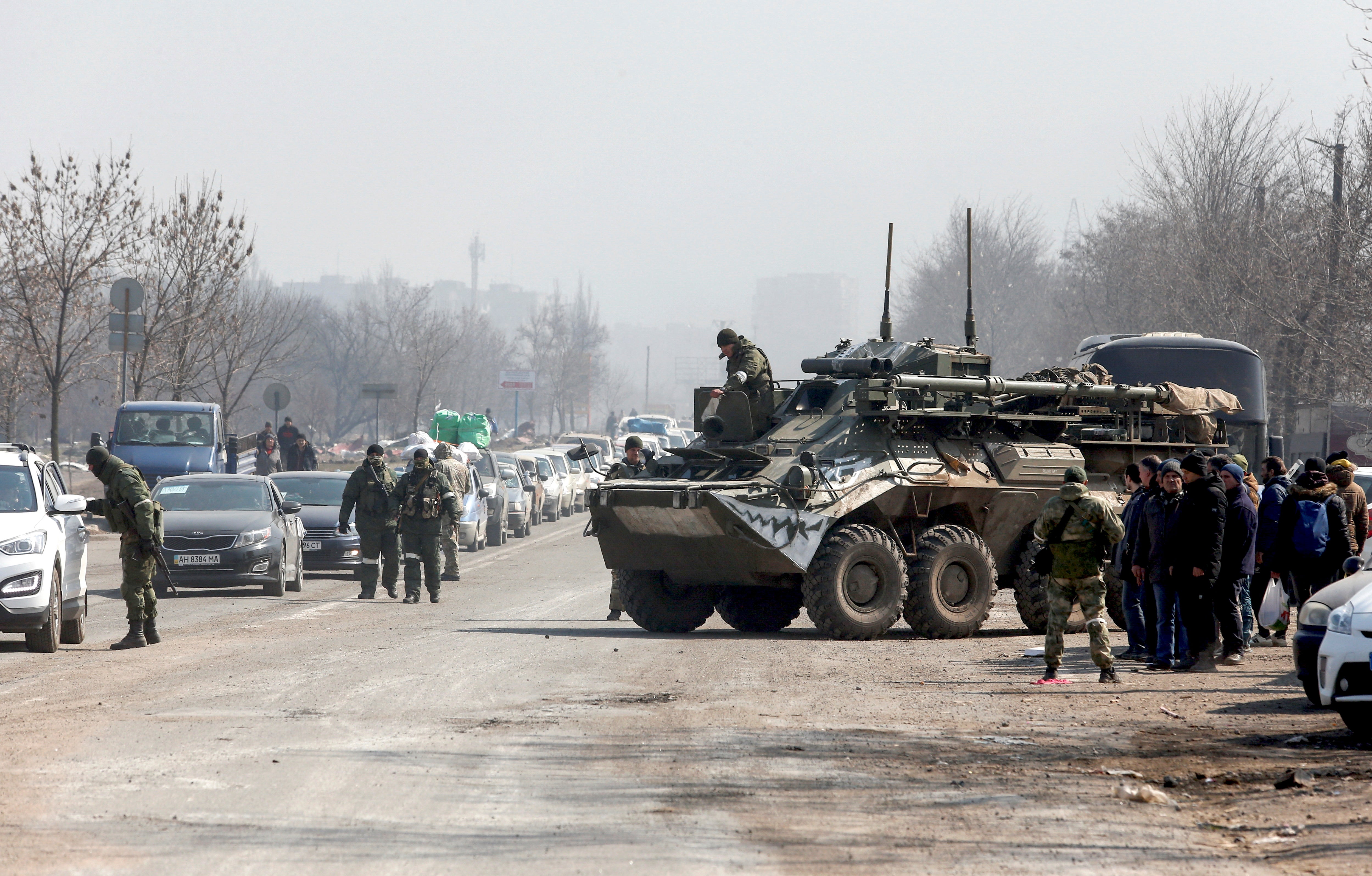 An armoured personnel carrier of pro-Russian troops drives towards a checkpoint in the besieged southern port city of Mariupol