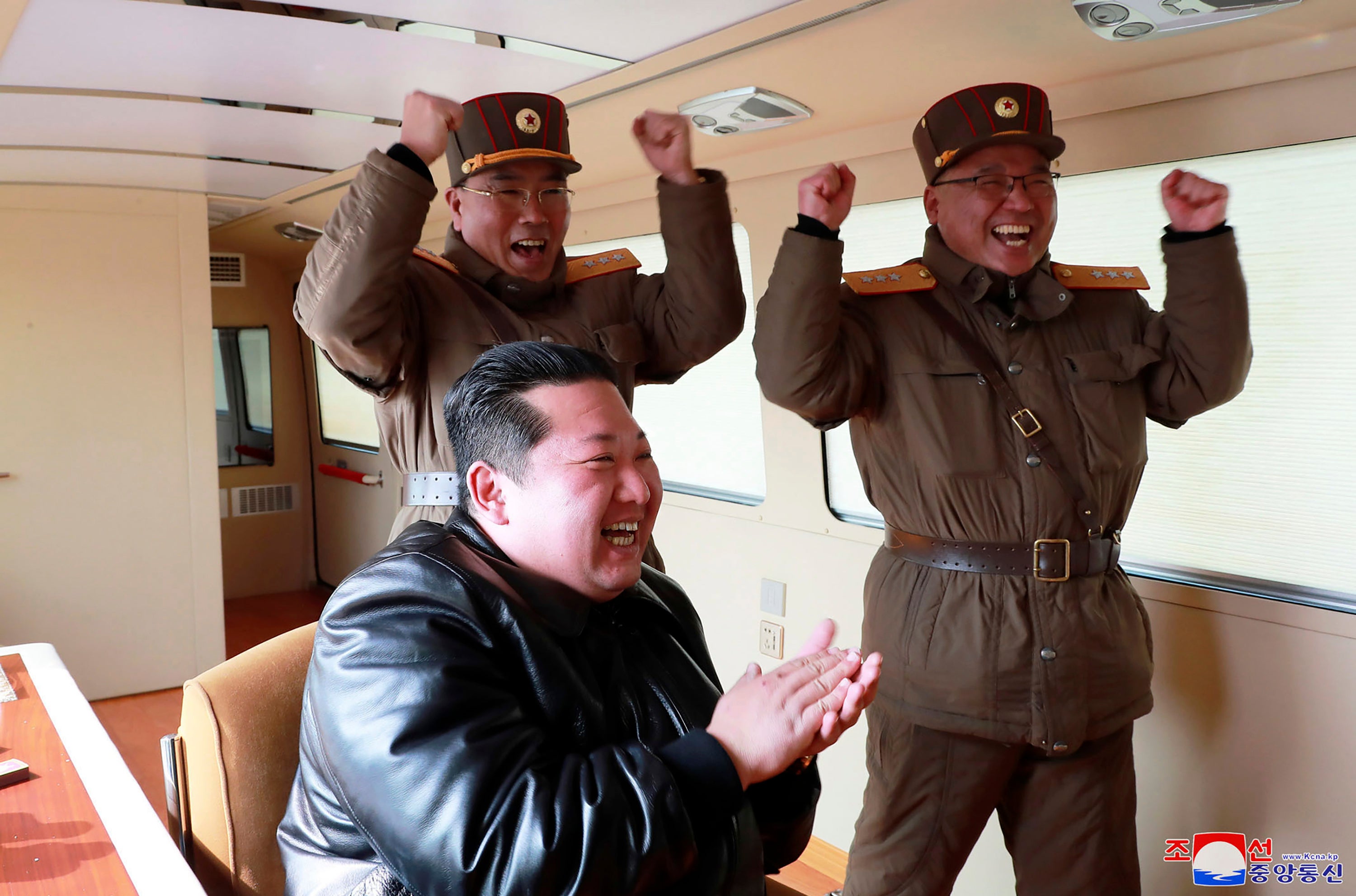 Kim Jong-un, front, claps during a test fire of what it says is the Hwasong-17 ICBM at an undisclosed location in North Korea on 24 March. Independent journalists were not given access to cover the event depicted in this image distributed by the North Korean government