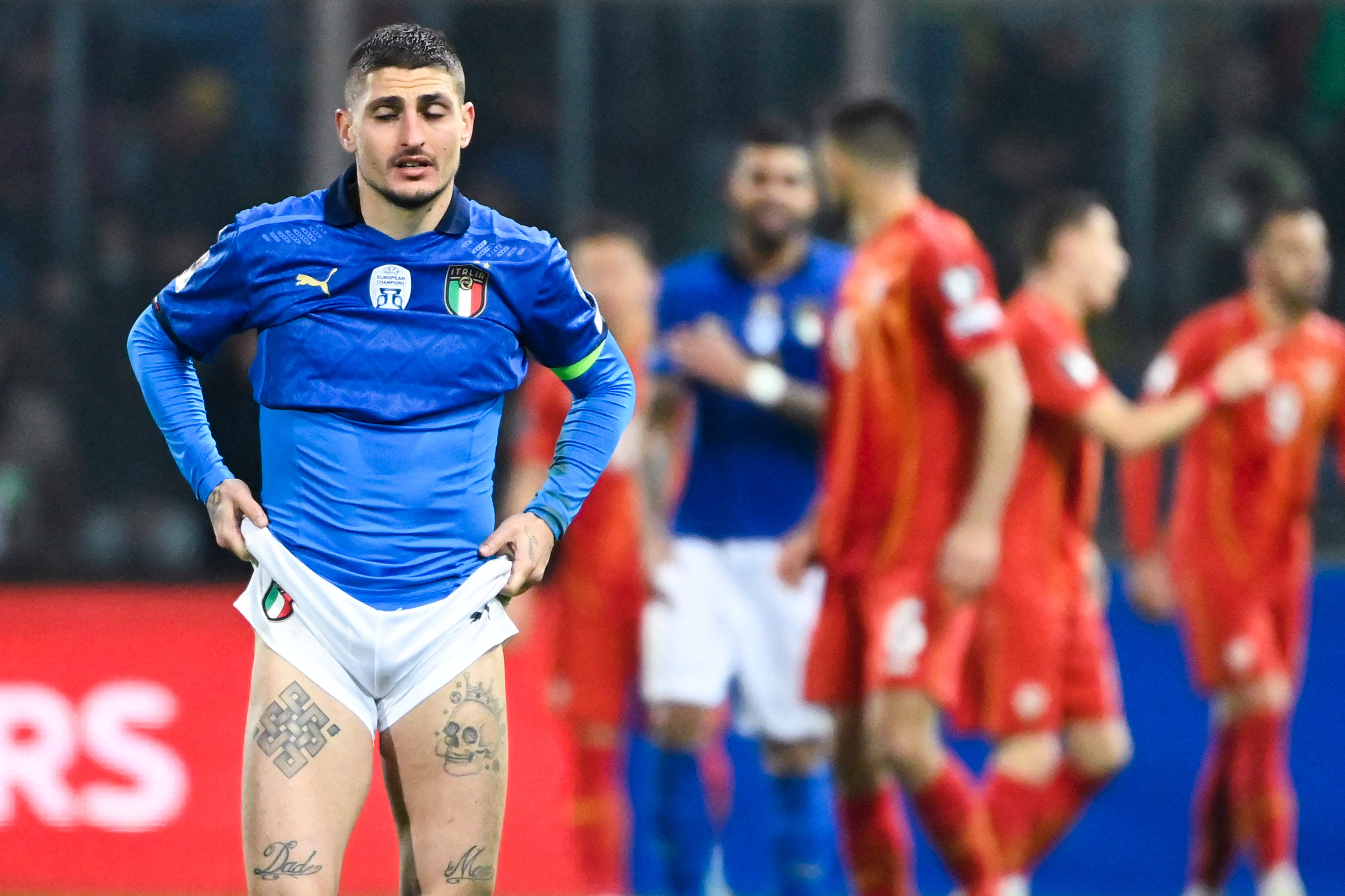 Italy’s midfielder Marco Verratti reacts after defeat