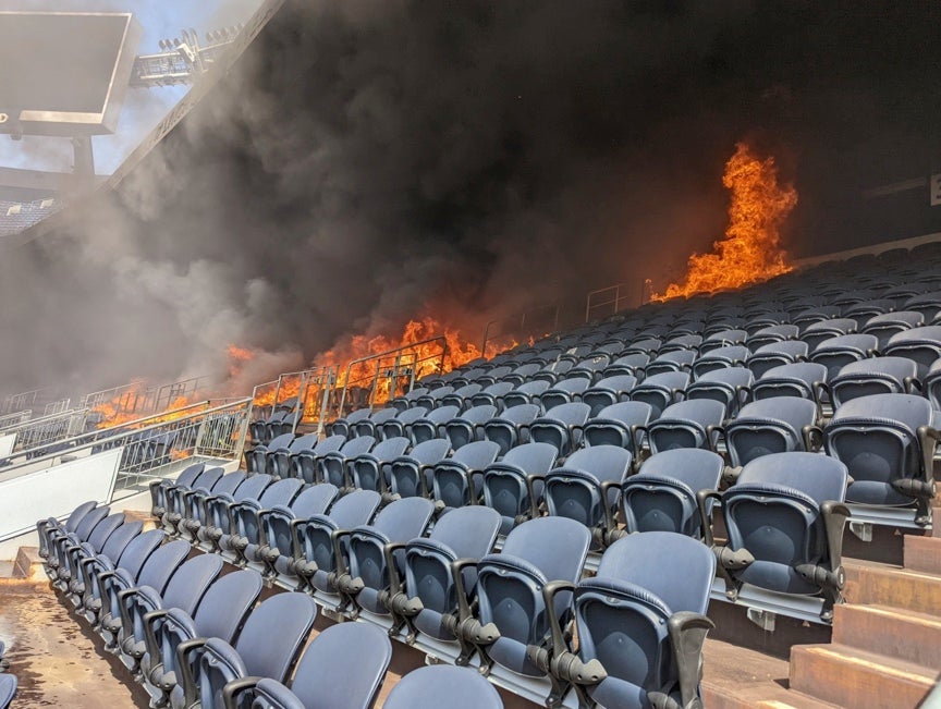 Roaring flames and heavy smoke engulf part of Empire Field at Mile High stadium