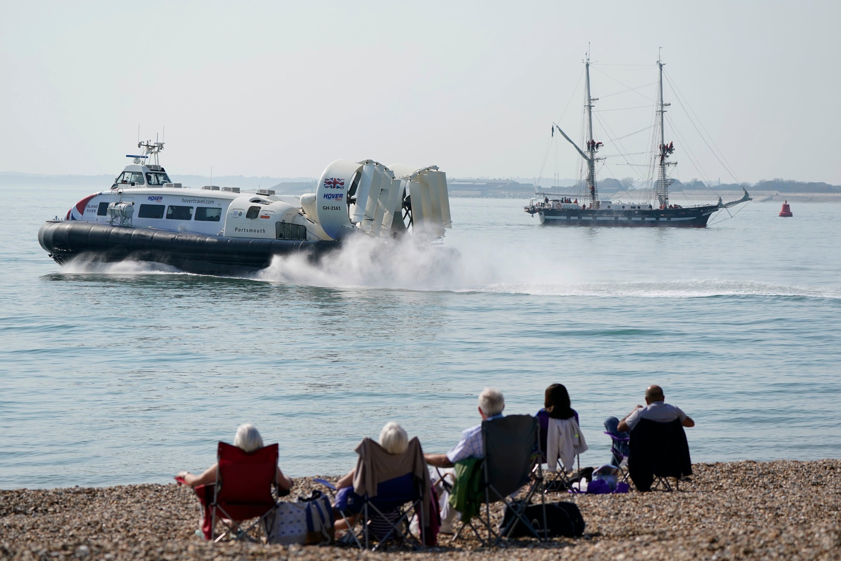 People look on from Southsea beach as the Isle of Wight