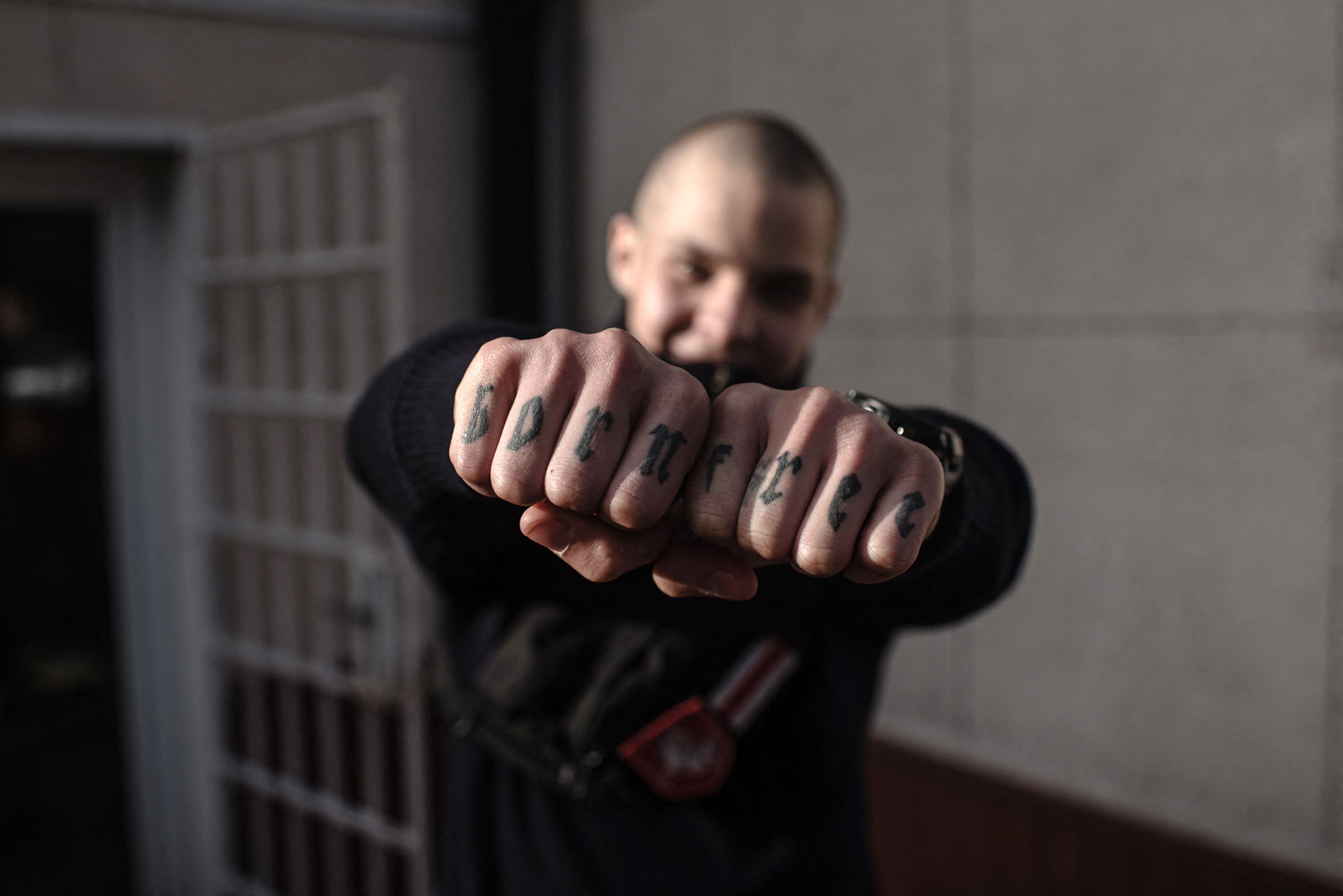 Belarusian teenager Gleb Gunko shows his 'born free' knuckle tattoos in Warsaw. While the regime in Belarus is Kremlin-aligned, many ordinary citizens are siding with Ukraine and even taking up arms