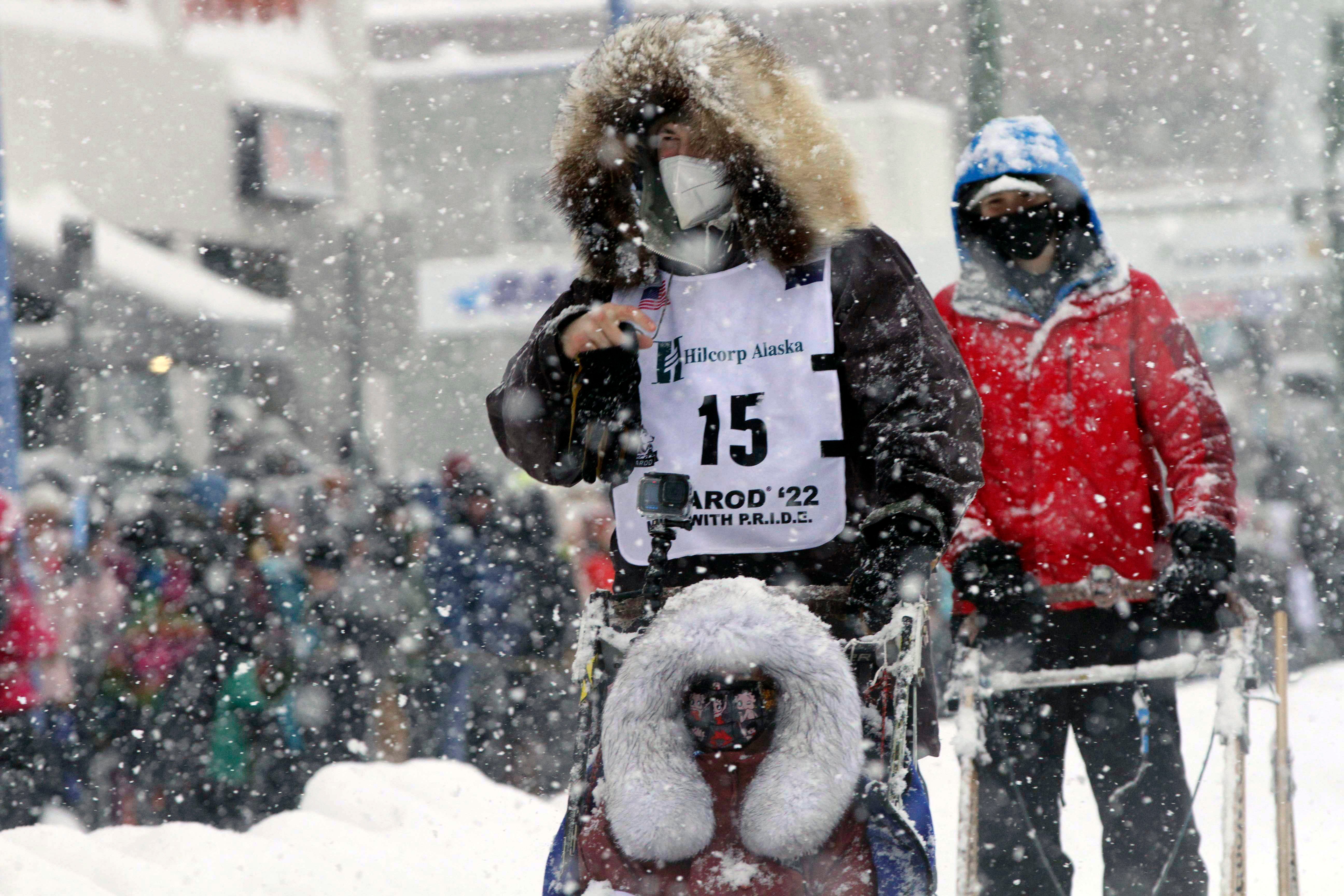 Riley Dyche, a musher from Fairbanks, Alaska, takes his sled dogs through a snowstorm in downtown Anchorage, Alaska, March 5, 2022