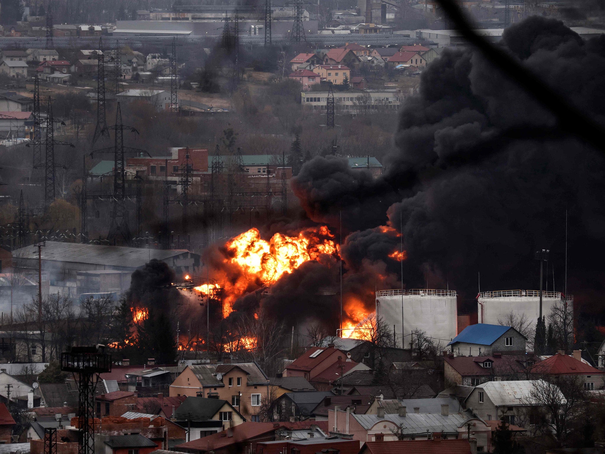 Dark smoke and flames rise from a fire following an air strike in Lviv on Saturday