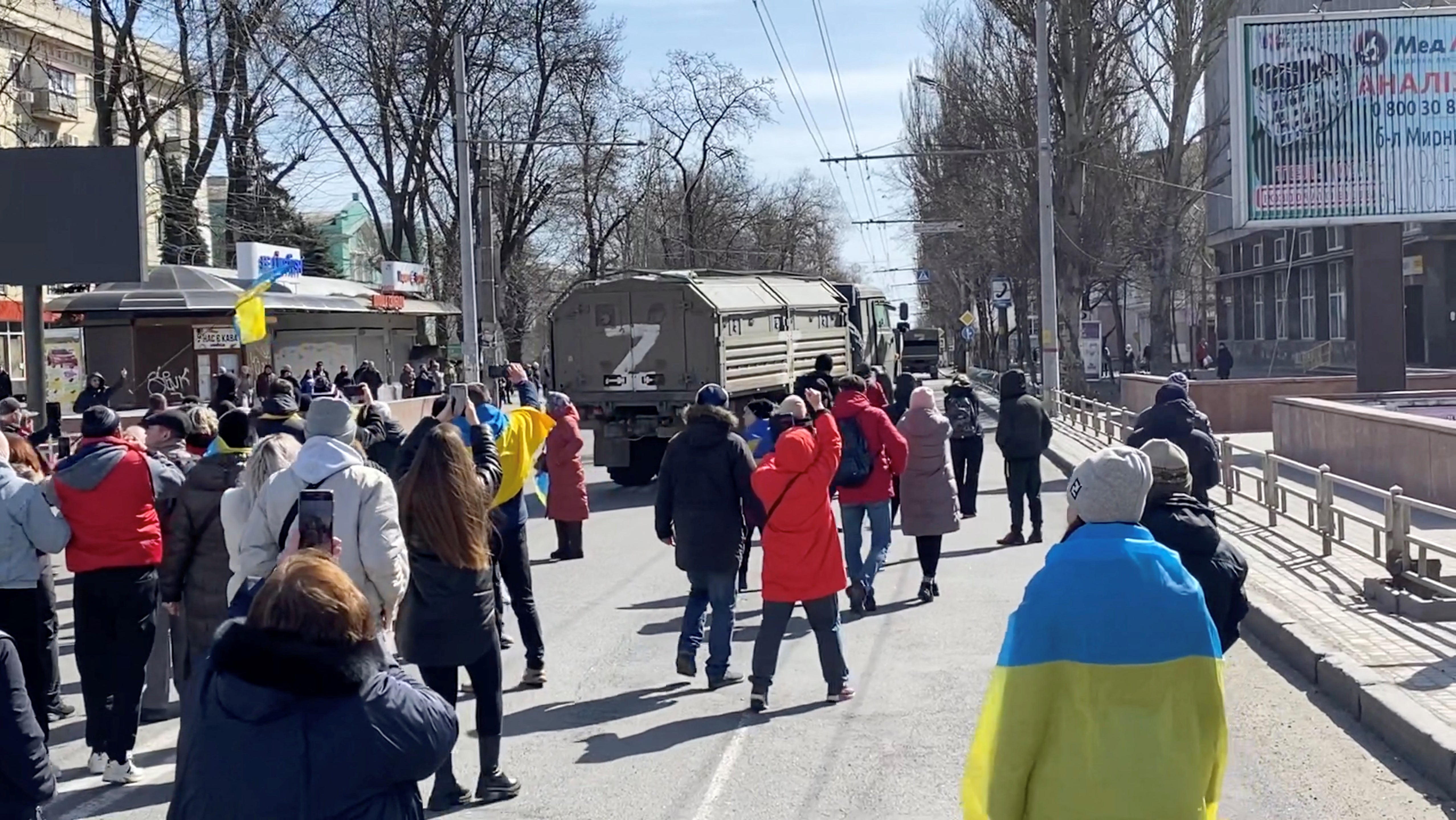 Protesters chant ‘go home’ at Russian military vehicles at a pro-Ukraine rally in Kherson on Monday