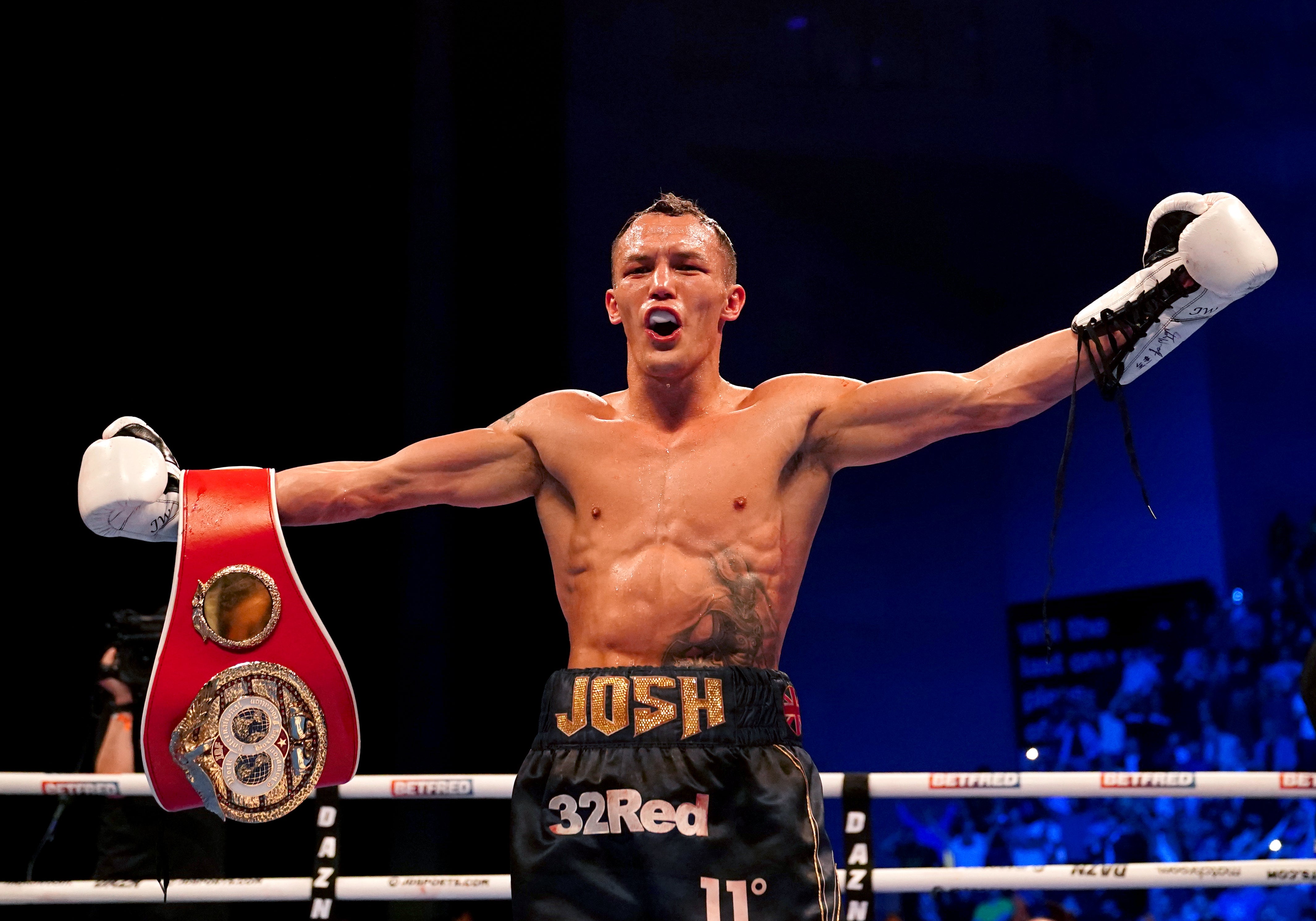 Josh Warrington celebrates after regaining the IBF featherweight to become a two-time world champion (Martin Rickett/PA)