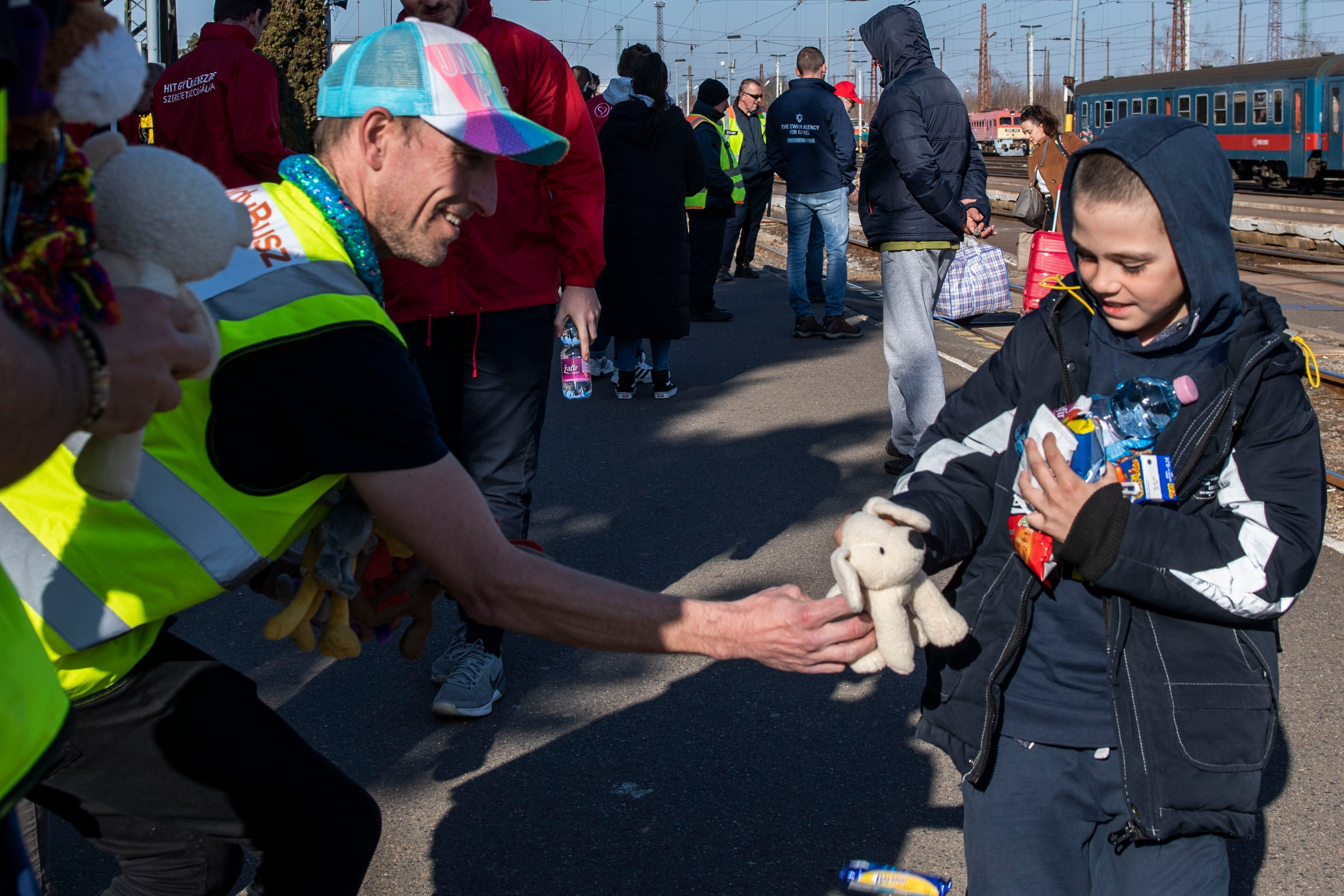 Two men hand out teddies to children, which they drove from Weston-super-Mare