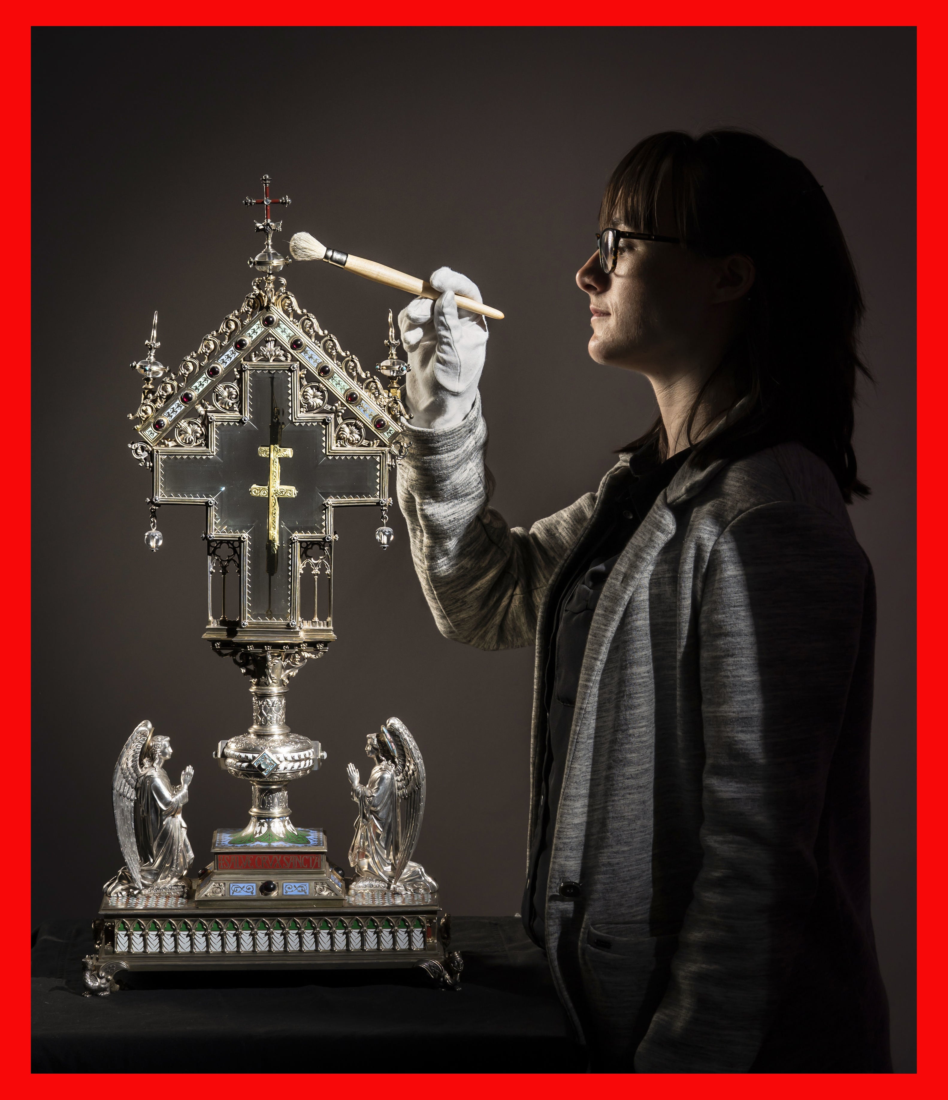 Special collections manager Dr Hannah Thomas cleans a True Cross relic, displayed in an ornate reliquary case made of silver gilt, precious stones and crystal, at The Bar Convent Living Heritage Centre in York, as the convent marks Easter with the discovery of previously unseen authentication and provenance documents (PA)