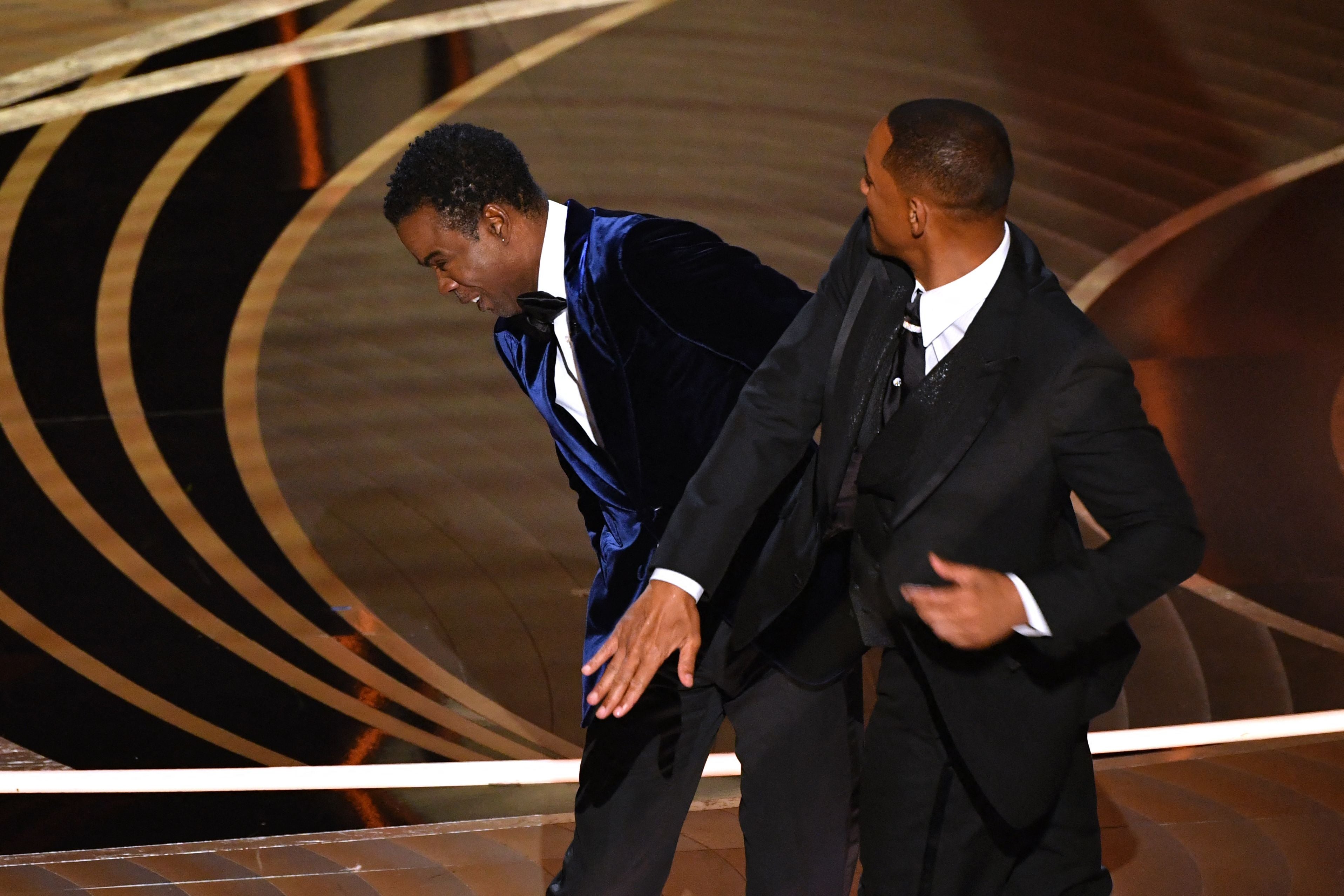 US actor Will Smith (R) slaps US actor Chris Rock onstage during the 94th Oscars at the Dolby Theatre in Hollywood, California