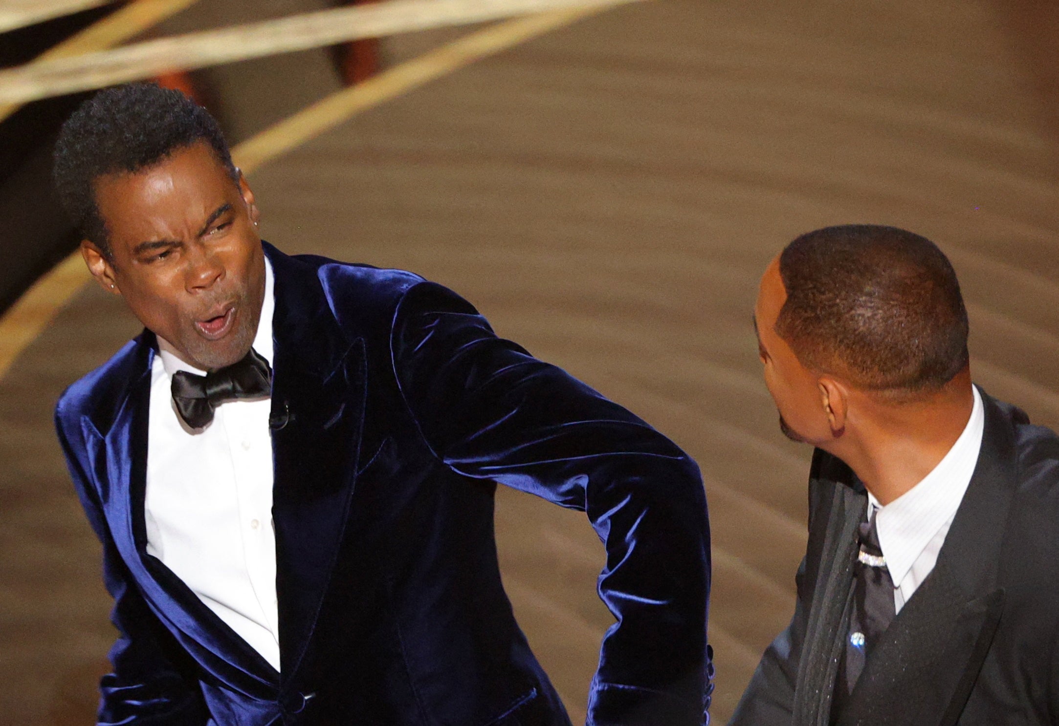 Will Smith slaps Chris Rock on stage at the 2022 Oscars