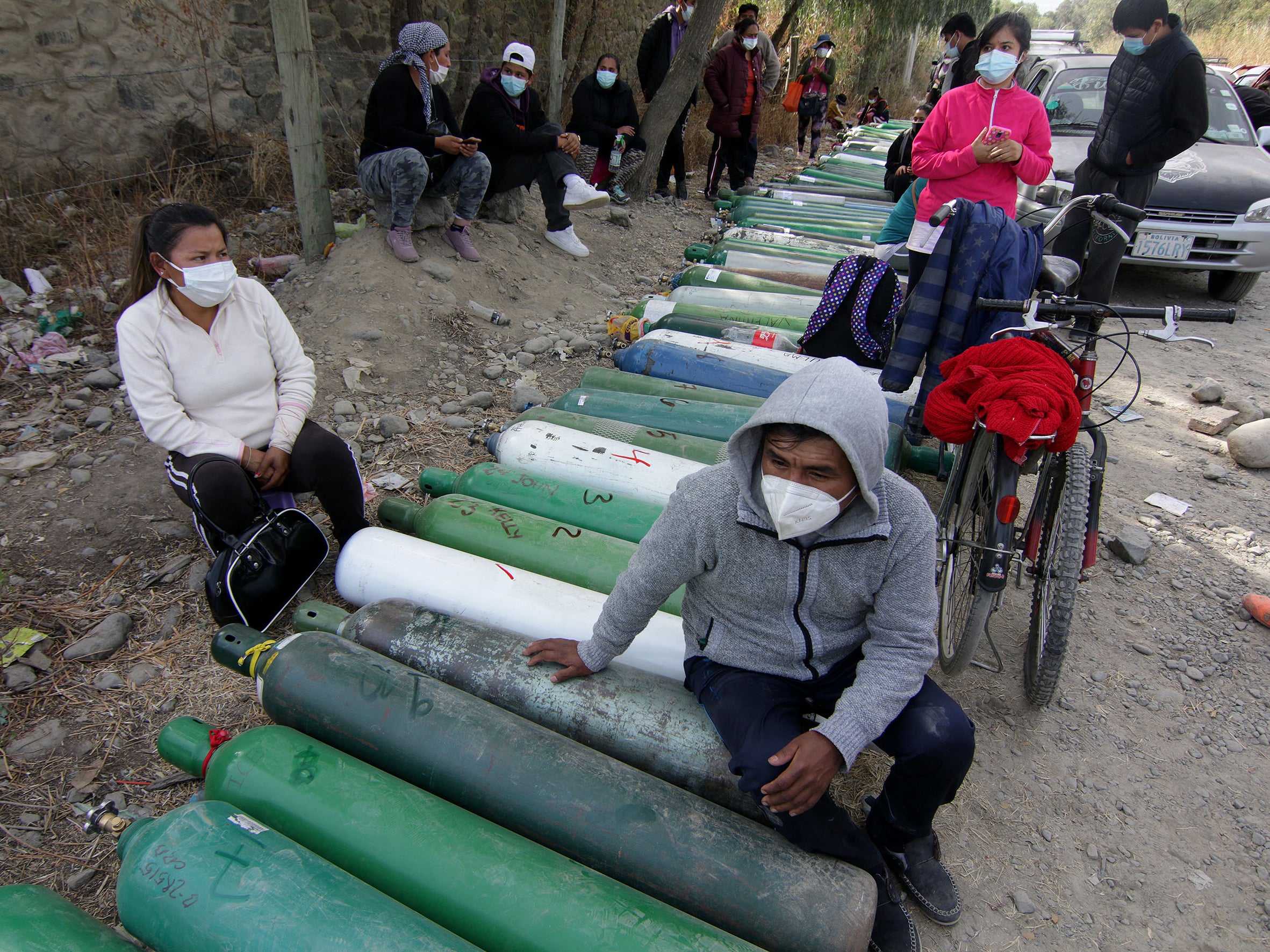 Relatives of Covid patients wait to get oxygen tanks refilled amid shortages in Bolivia in June 2021