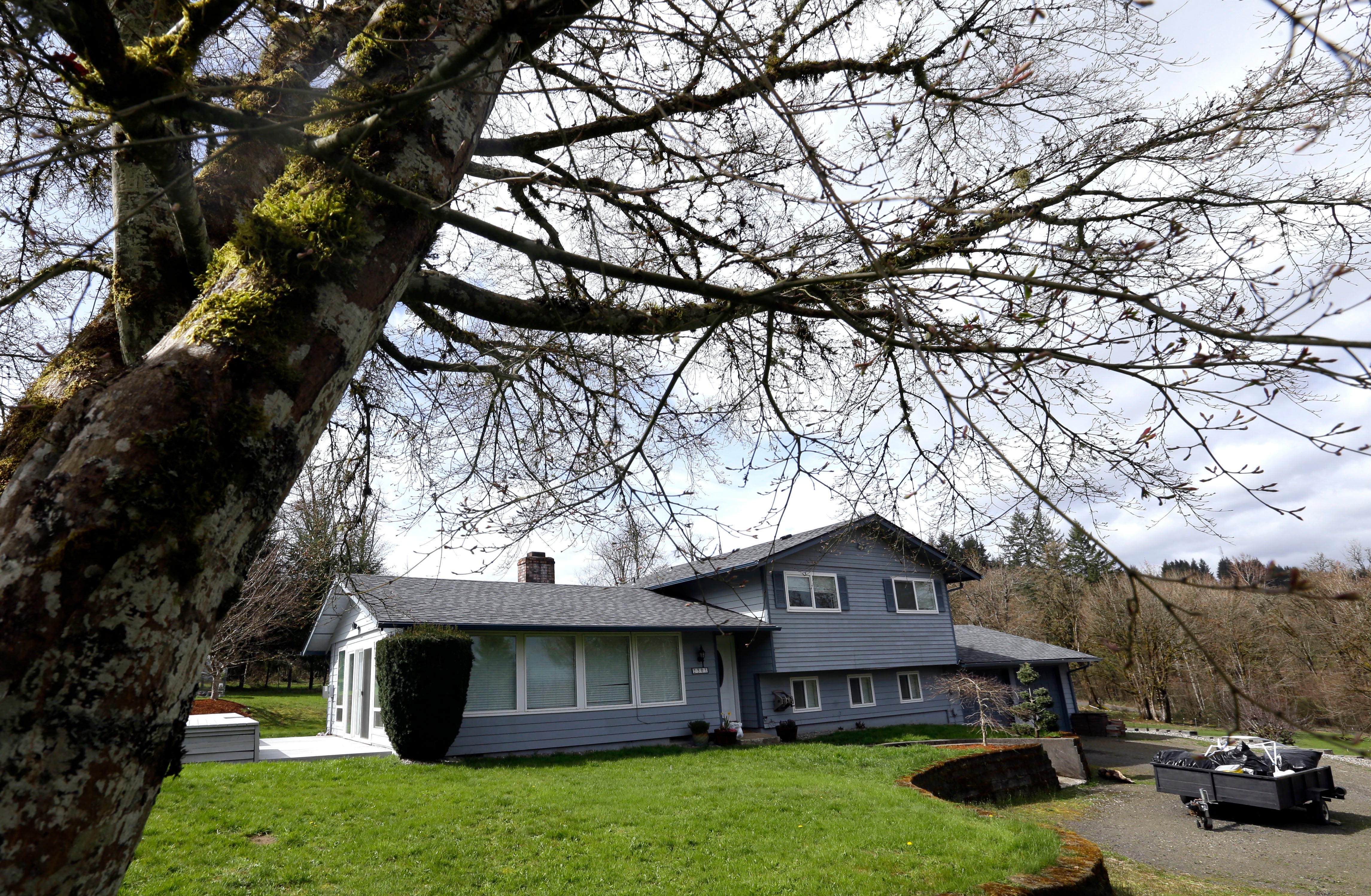 The Hart family lived in this two-story home with a fenced pasture in Woodland, Washington; neighbours said the children turned up looking for food and protection from their mothers