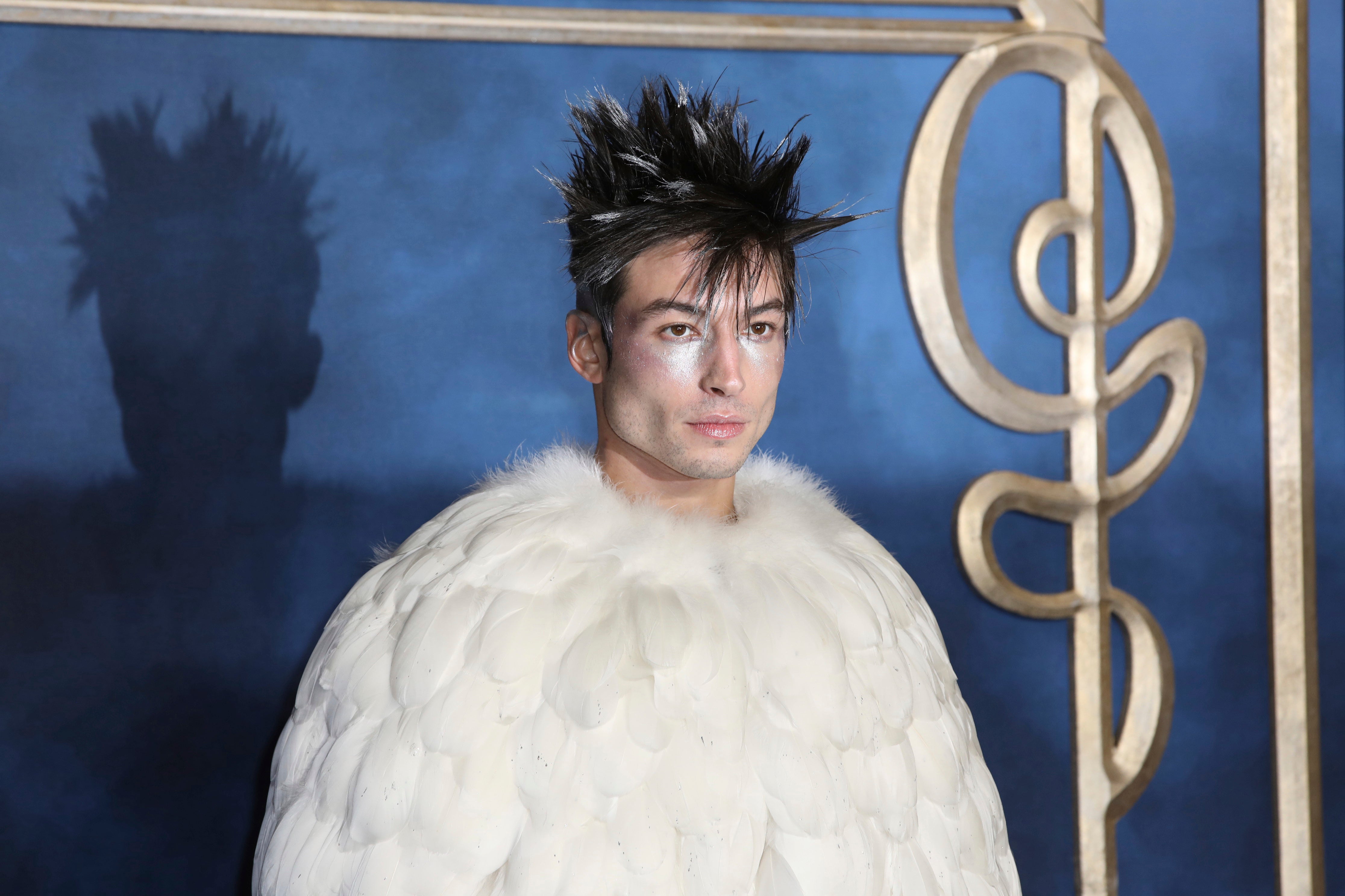 Actor Ezra Miller poses for photographers at the premiere of the film Fantastic Beasts: The Crimes of Grindelwald in 2018