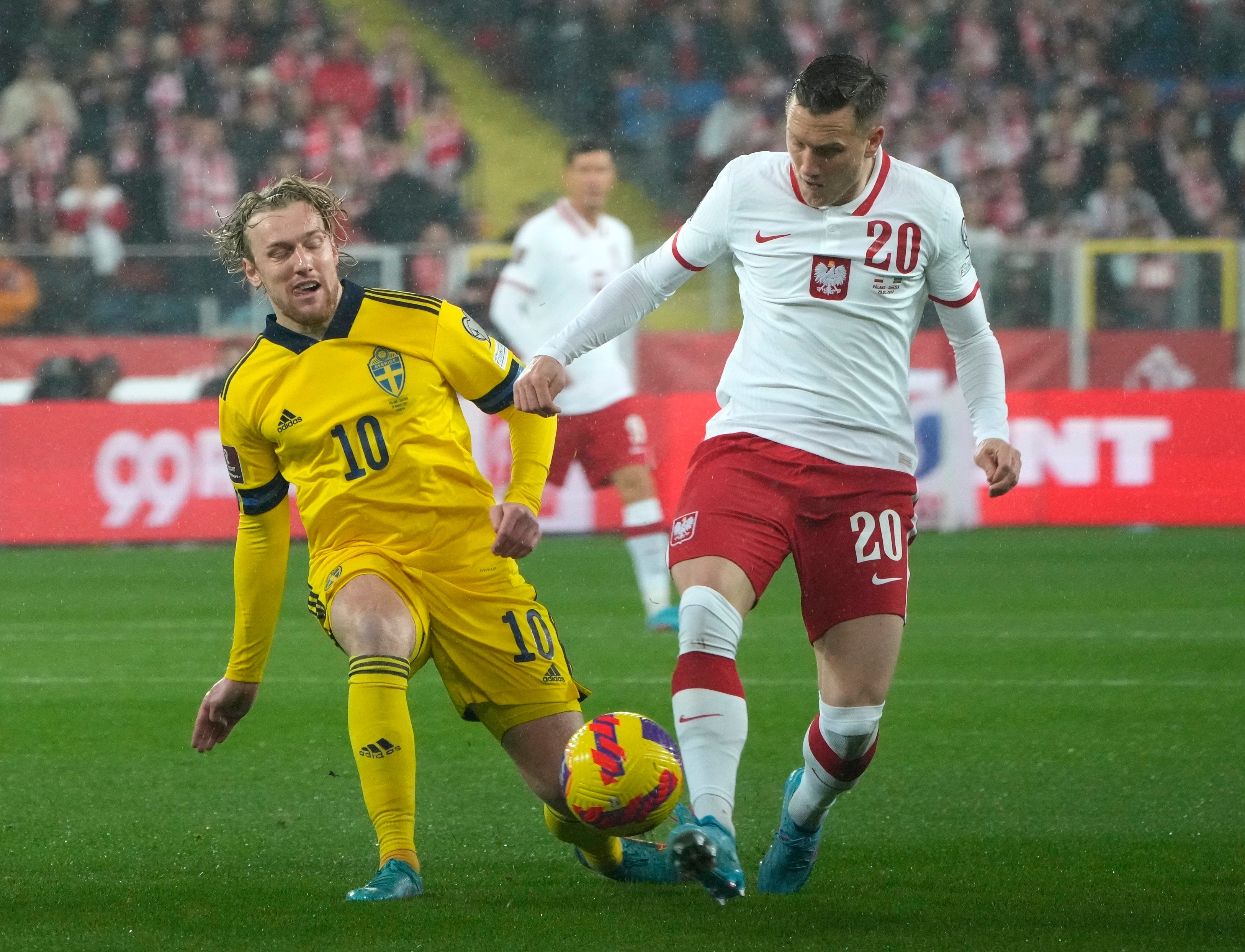 Piotr Zielinski (right) sealed Poland’s place in Qatar (Czarek Sokolowski/AP)