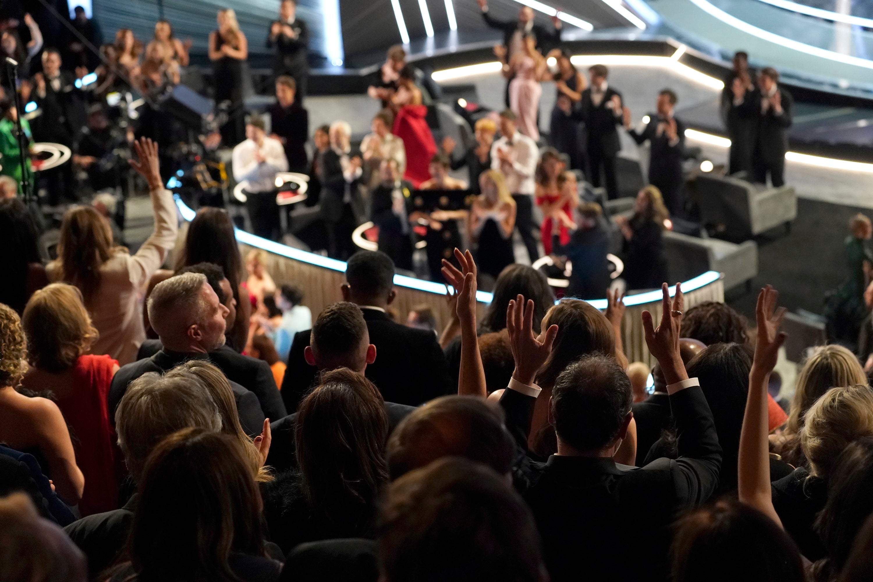 Audience members sign the word ‘applause’ as the cast and crew of ‘CODA’ receive Best Picture at last year’s Oscars