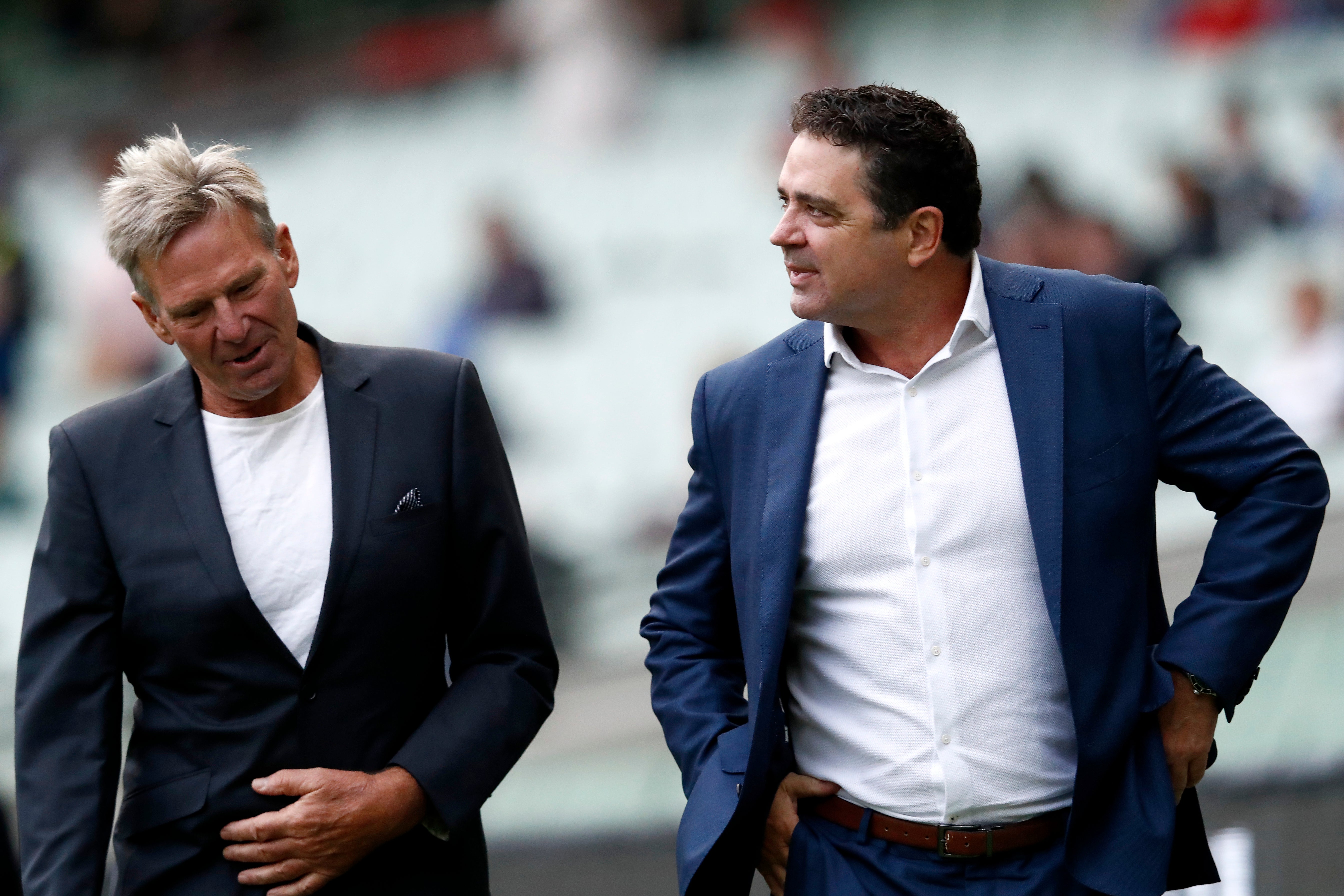 Former AFL players Garry Lyon (R) and Sam Newman attend the state memorial service