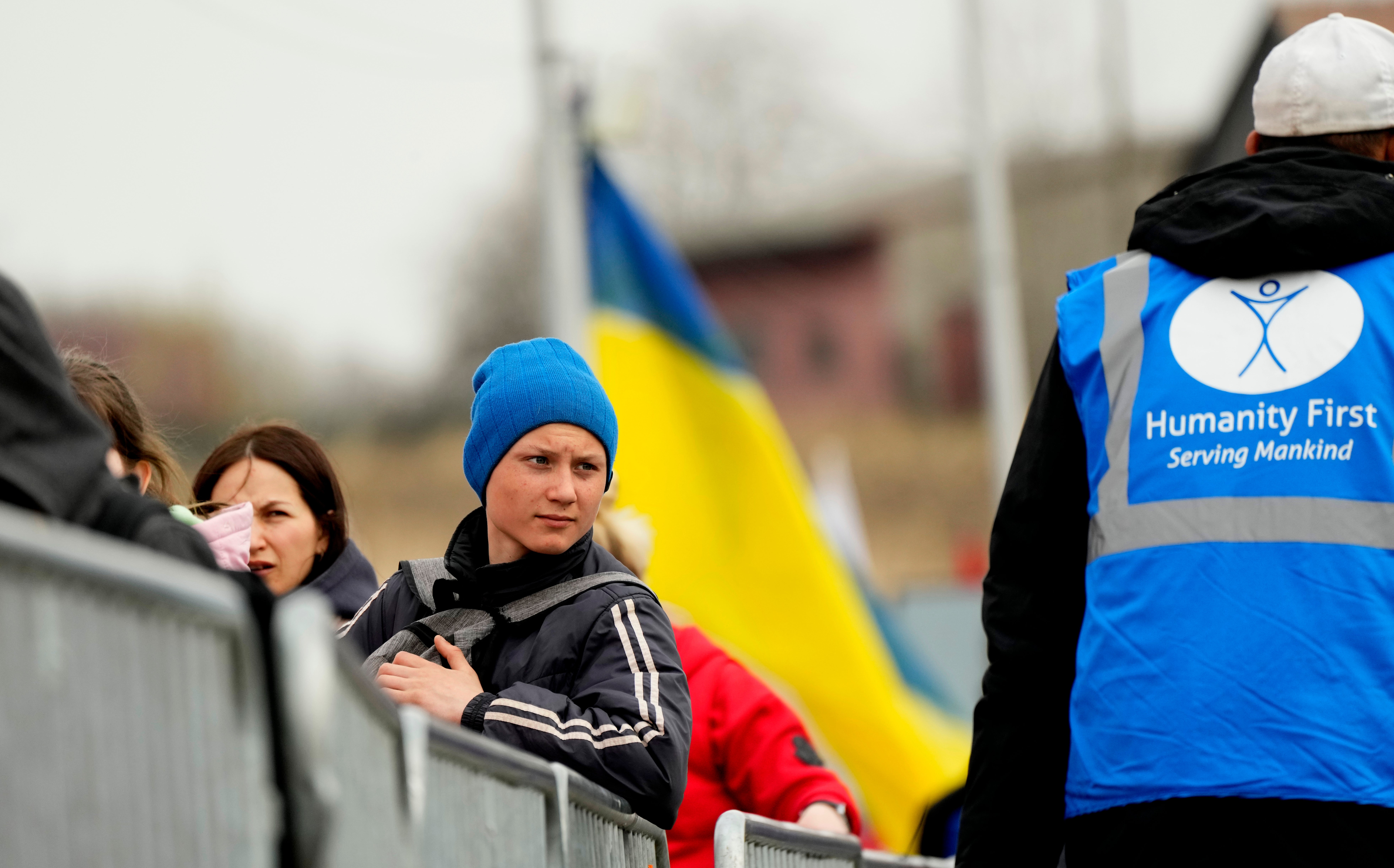 Refugees wait in a queue after fleeing the war in Ukraine (Sergei Grits/AP)