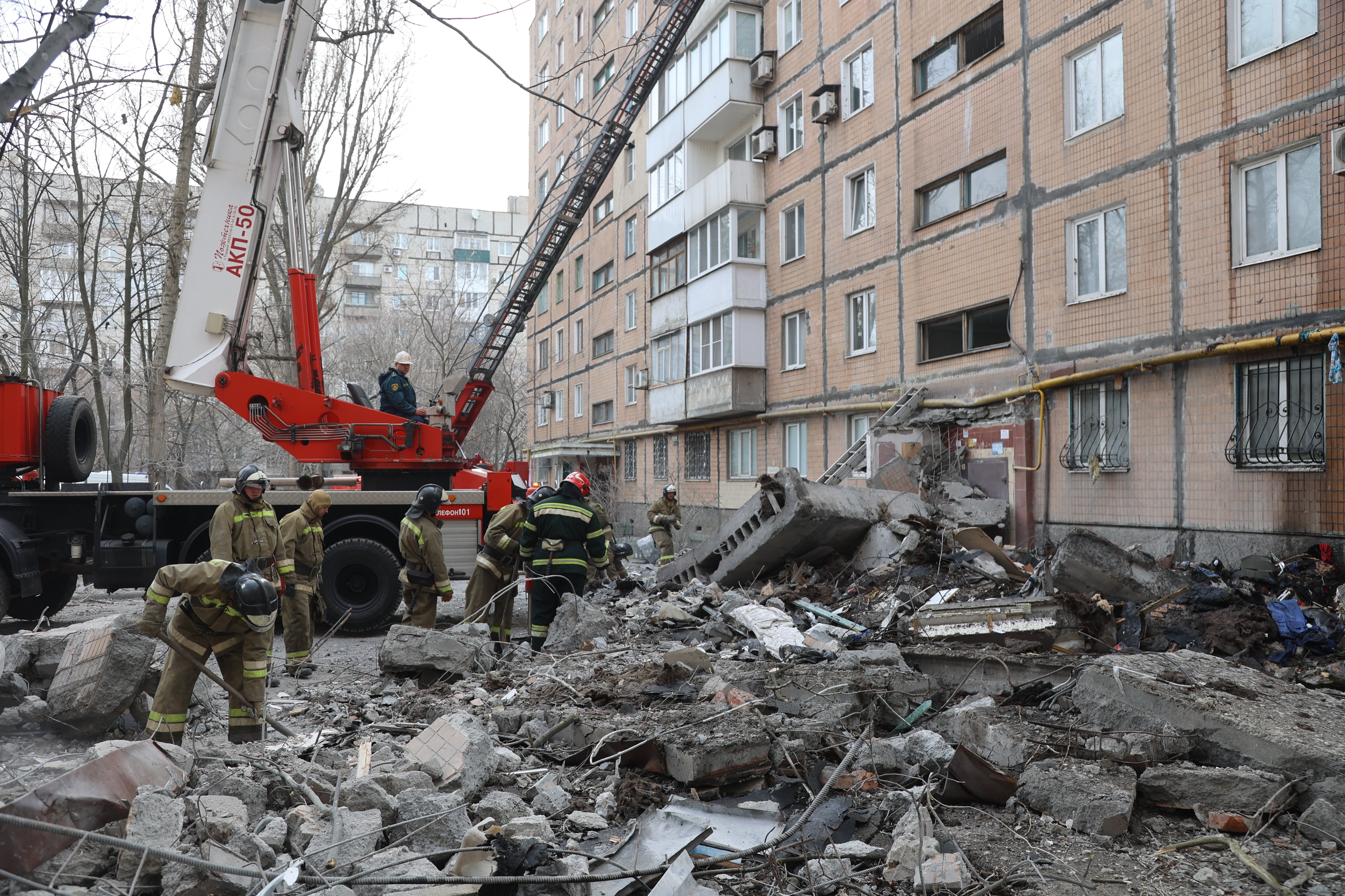 Firefighters clear debris after shelling in the pro-Russian separatists-controlled Donetsk, in Ukraine on March 30, 2022