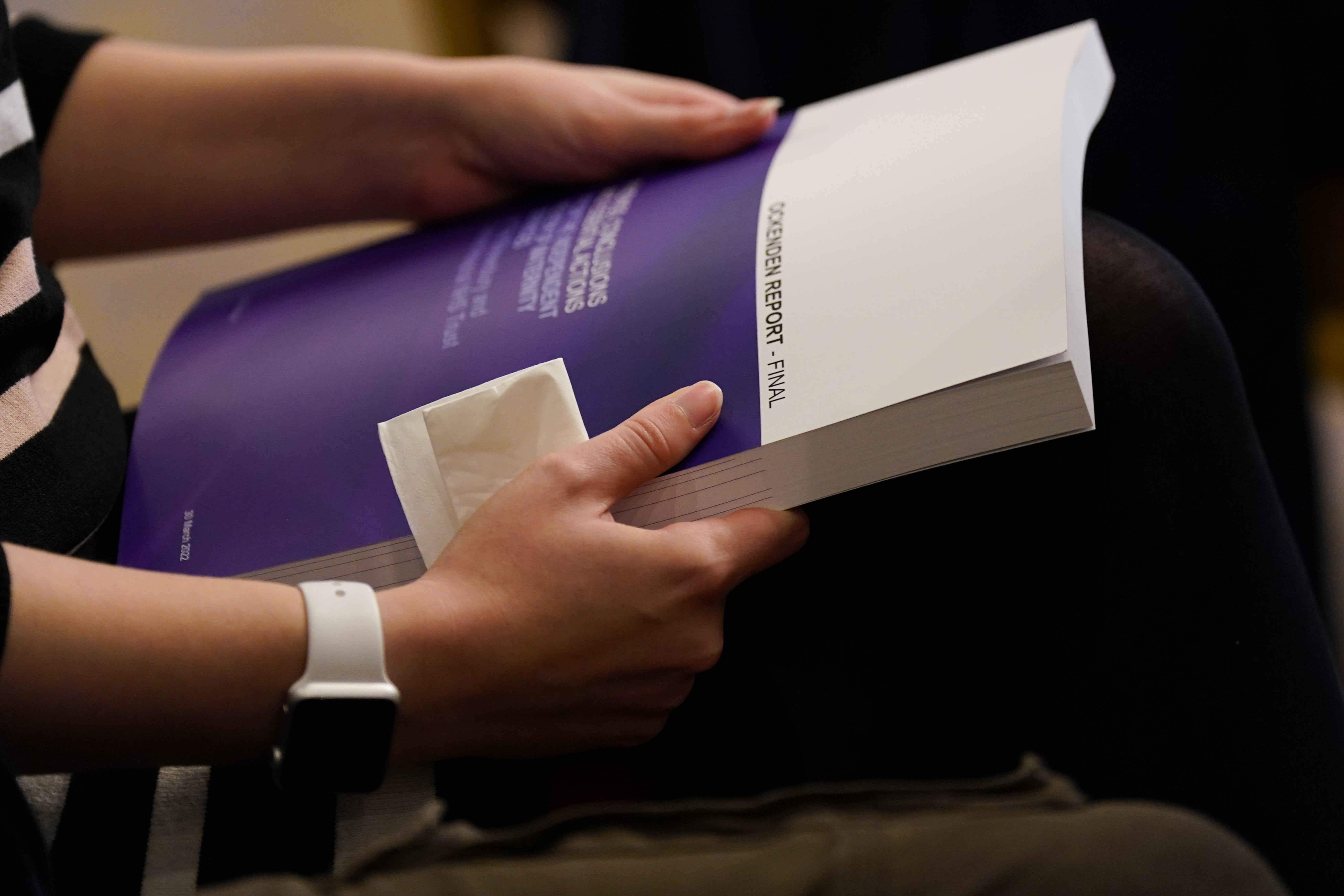 Kayleigh Griffiths holds the Ockenden report (Jacob King/PA)