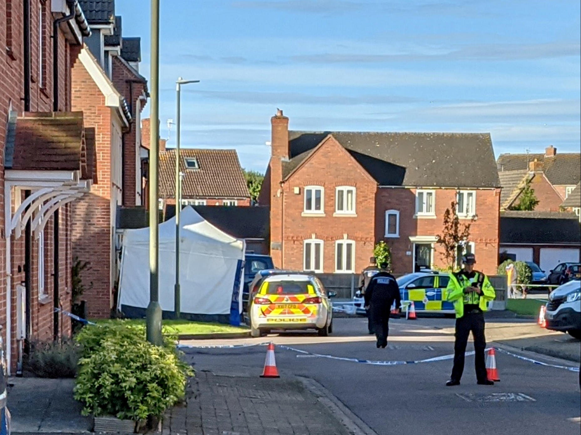 Police at the scene of the stabbing in Walton Cardiff near Tewkesbury, Gloucestershire