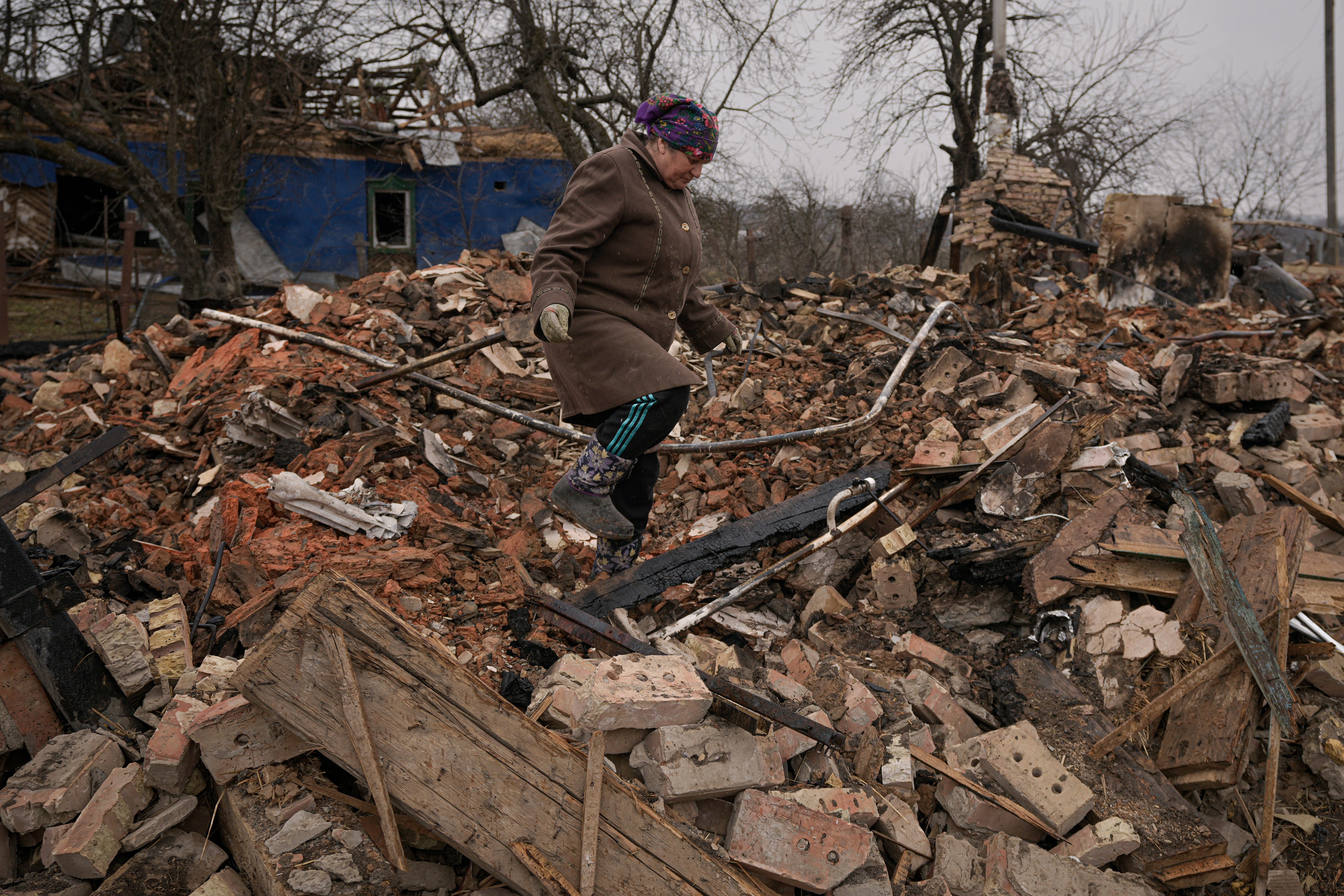 Mariya, a local resident, looks for personal items in the rubble of her house, destroyed during fighting between Russian and Ukrainian forces in the village of Yasnohorodka, on the outskirts of Kyiv, Ukraine