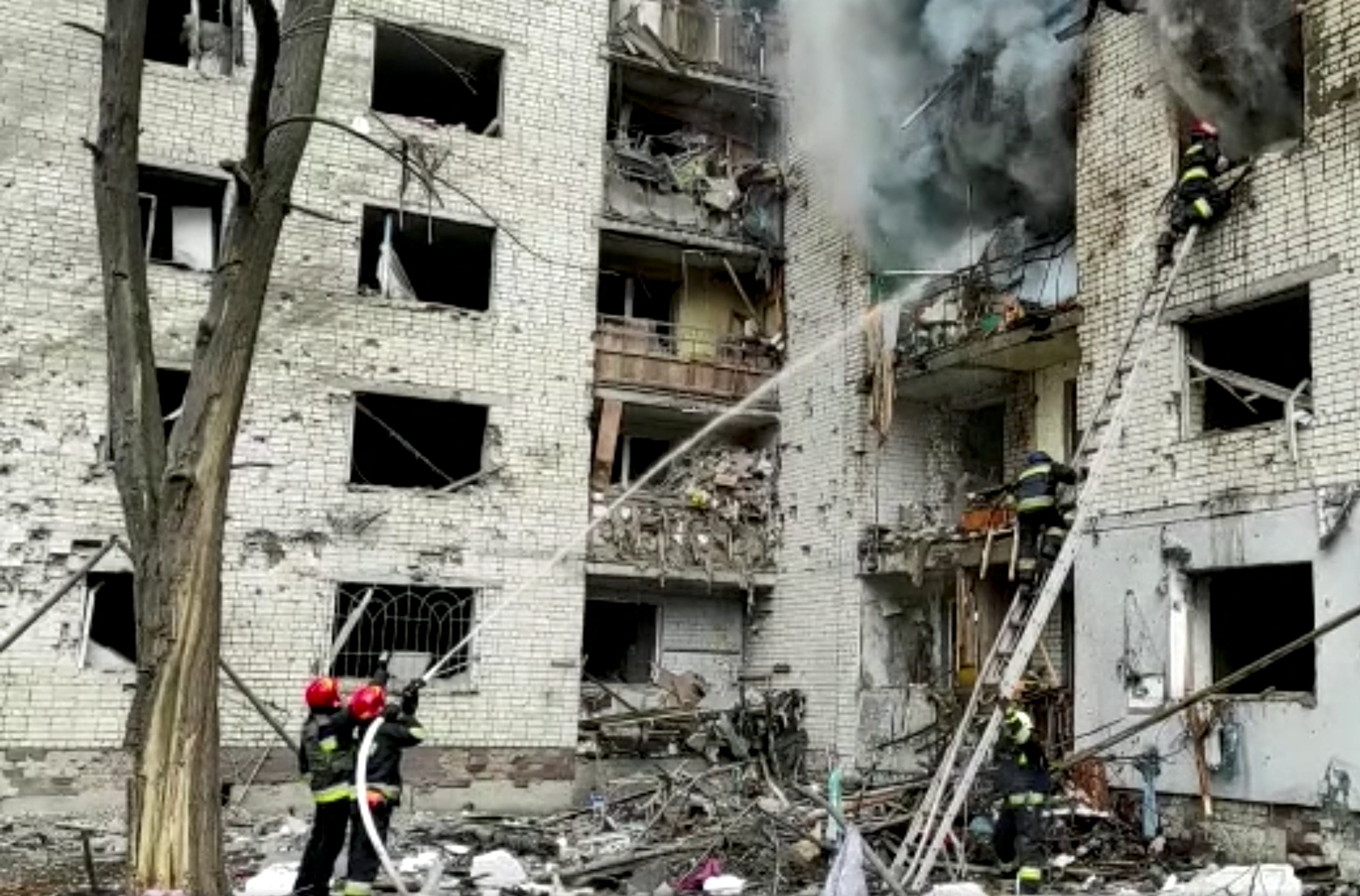 Firefighters battle a fire in a building after the shelling attack on 3 March