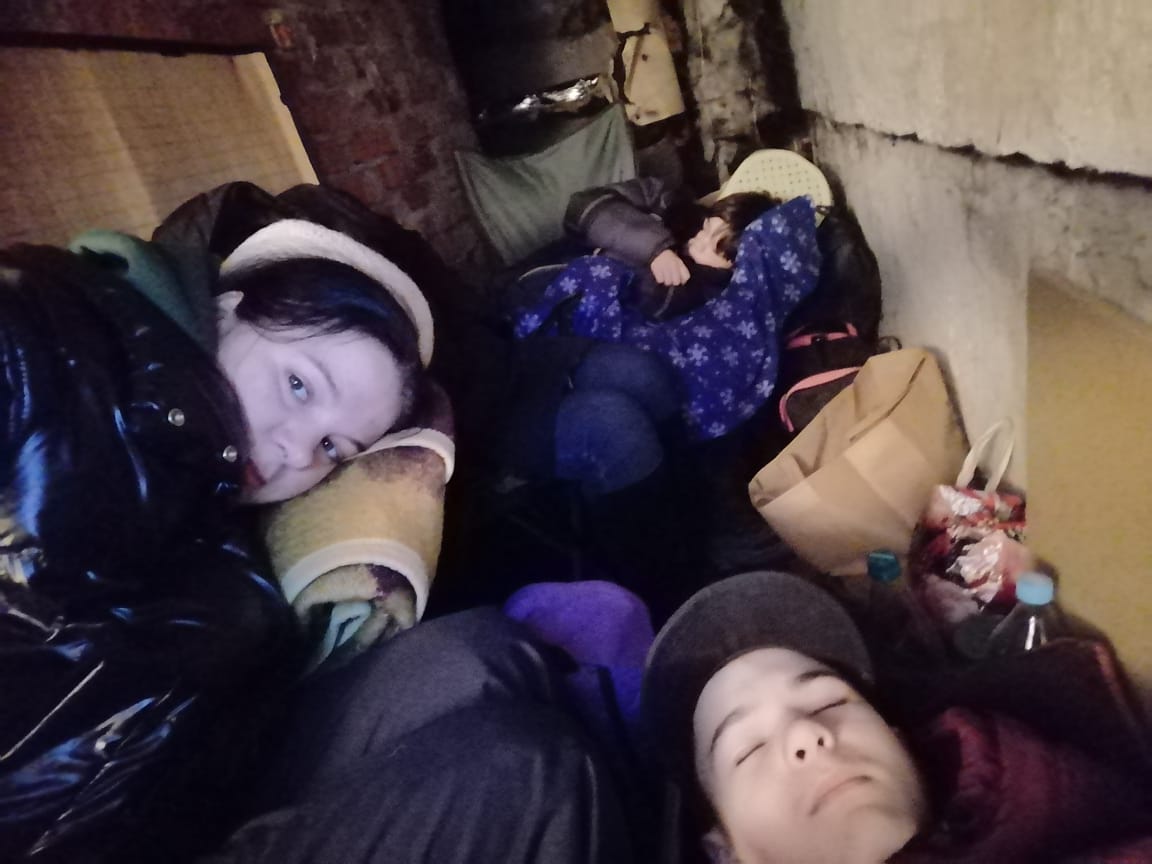 Yulia Zhdanova try to rest inside the basement of their home in Chernihiv before they evacuated the city