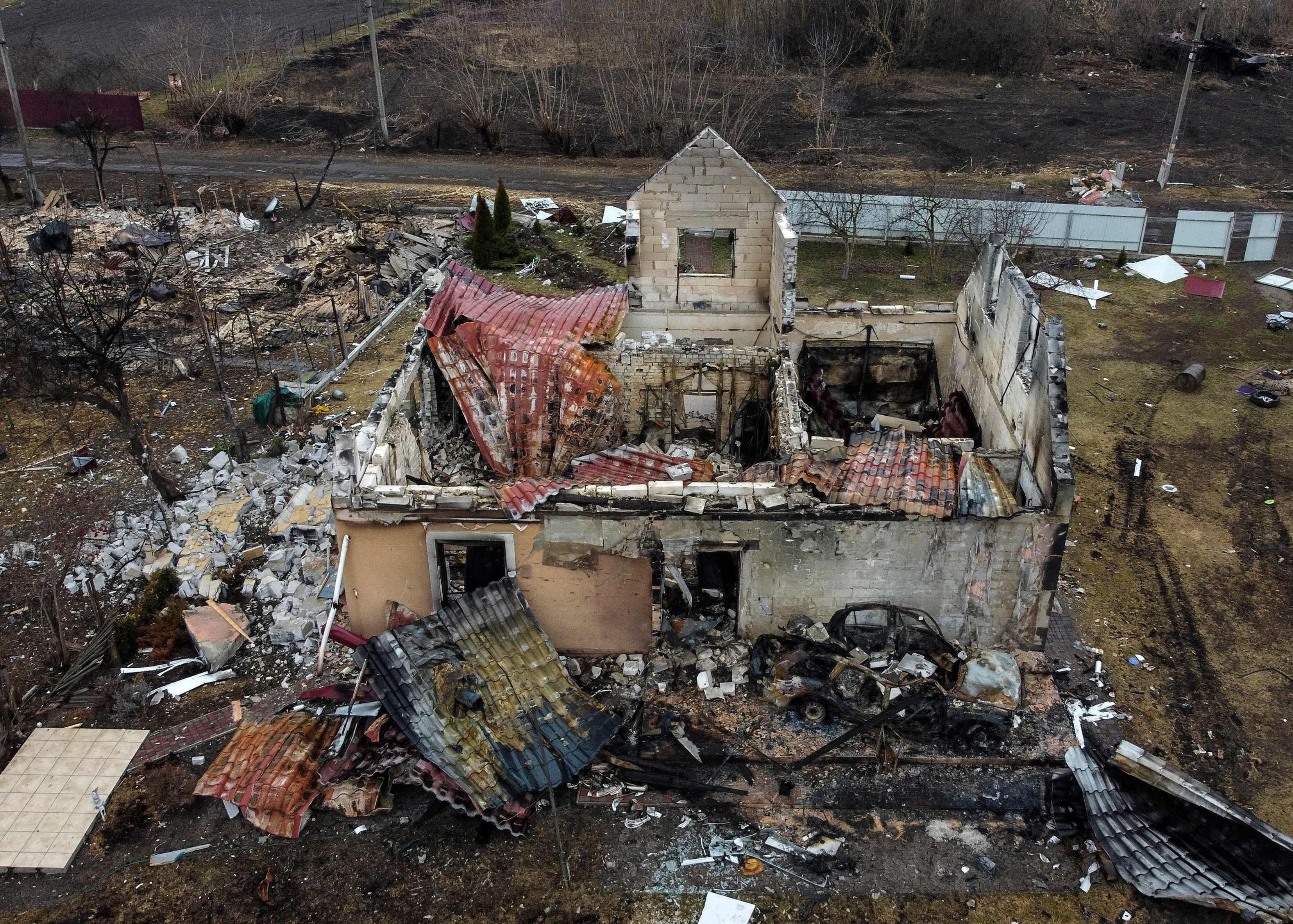 This aerial view taken near Kyiv on March 30, 2022 shows a destroyed house in the village of Lukianivka