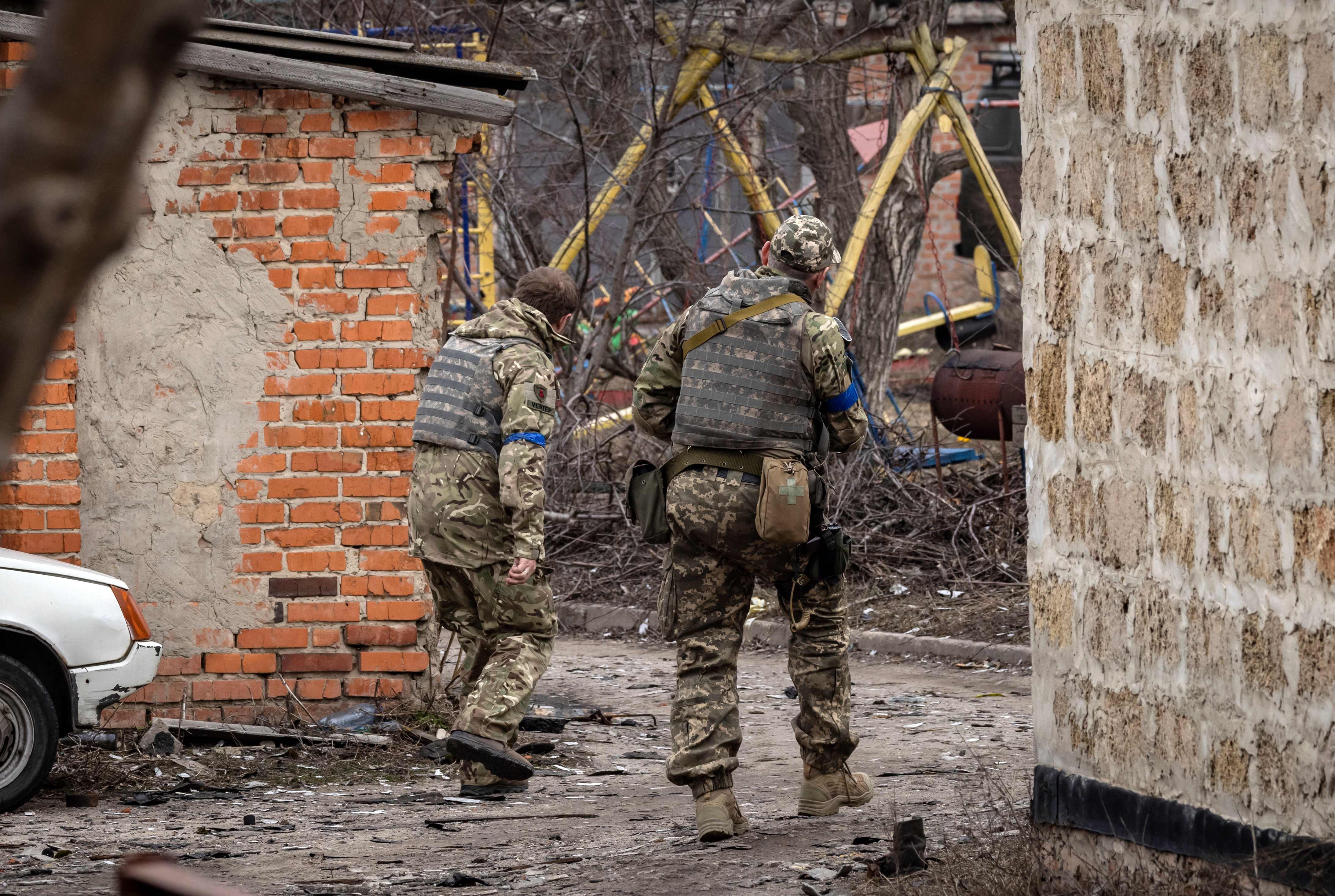 Ukrainian soldiers patrol in the village of Malaya Rohan, east of Kharkiv