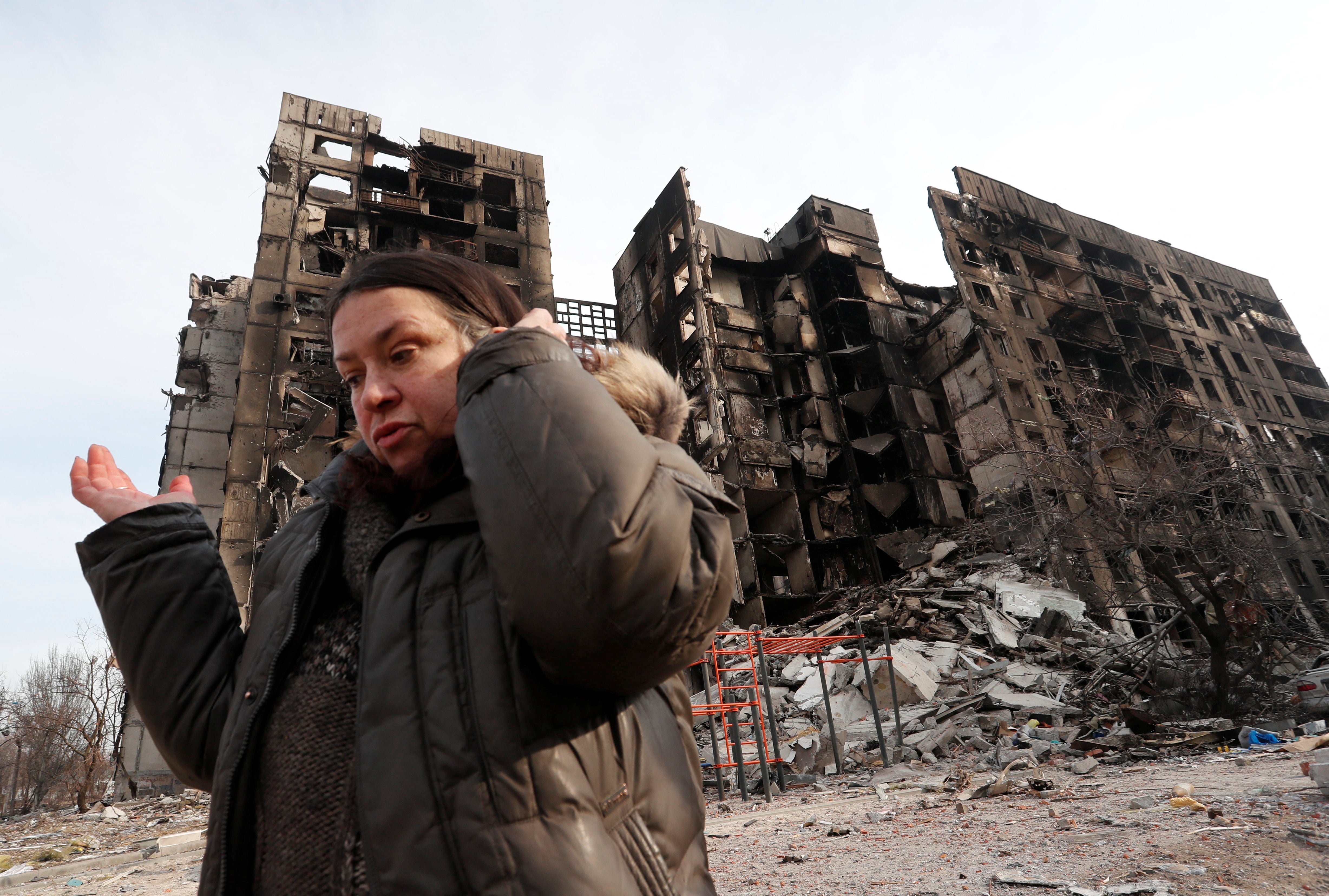 Nurse Svetlana Savchenko, 56, stands next to a building where her apartment was located in the besieged southern port city of Mariupol